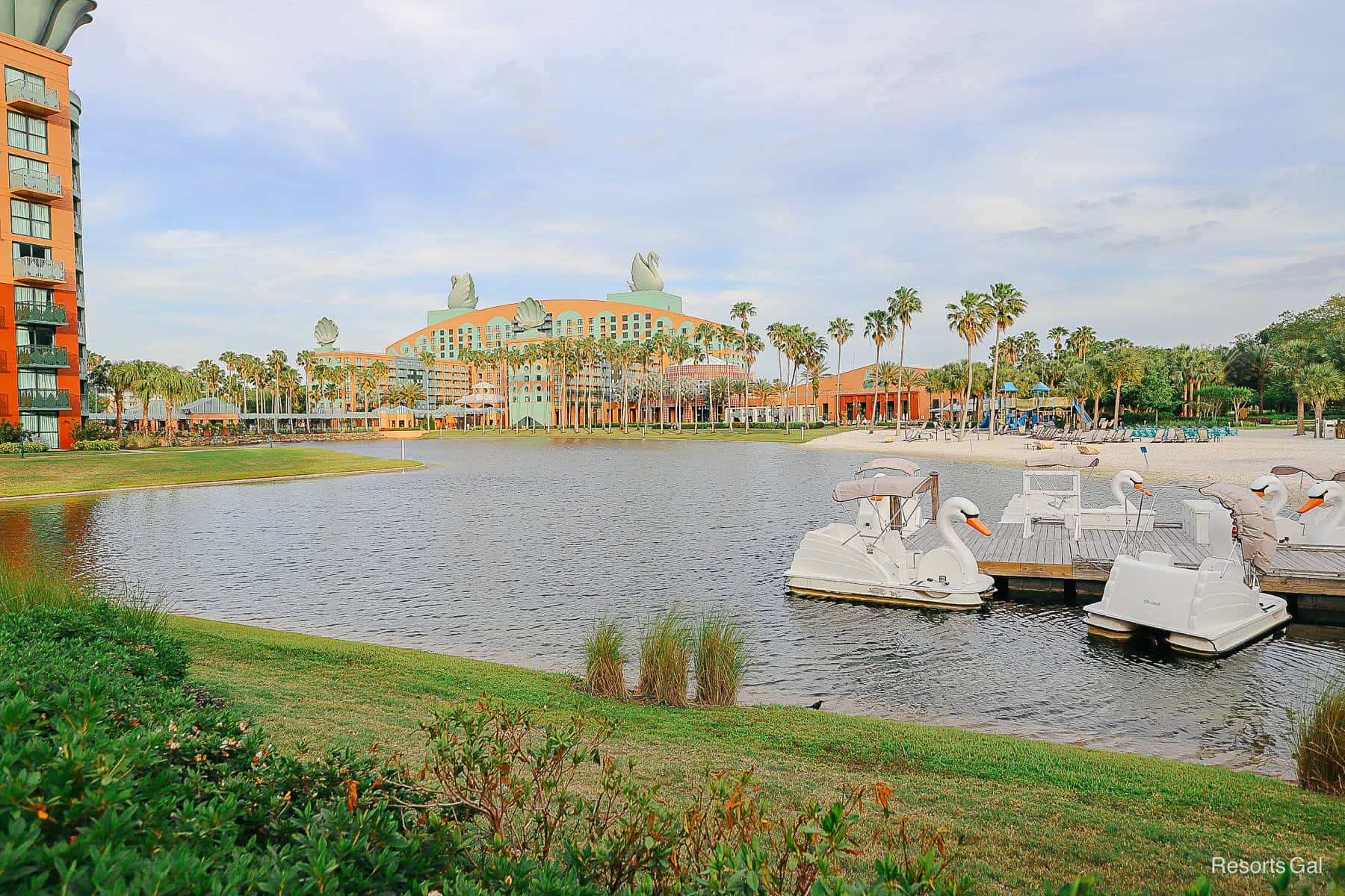 a scenic photo of Disney's Swan with Swan boats on the lake 