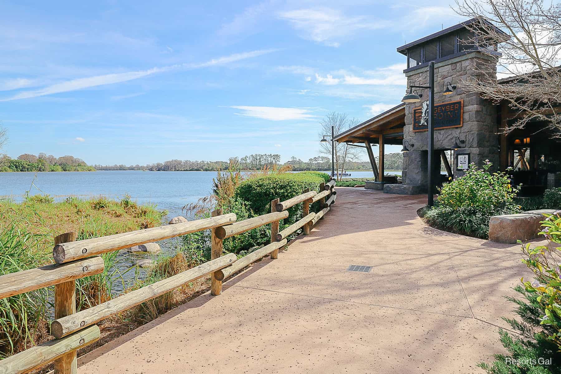 a scenic picture that shows how Geyser Point Bar and Grill sits on the lake at Disney's Wilderness Lodge Resort 