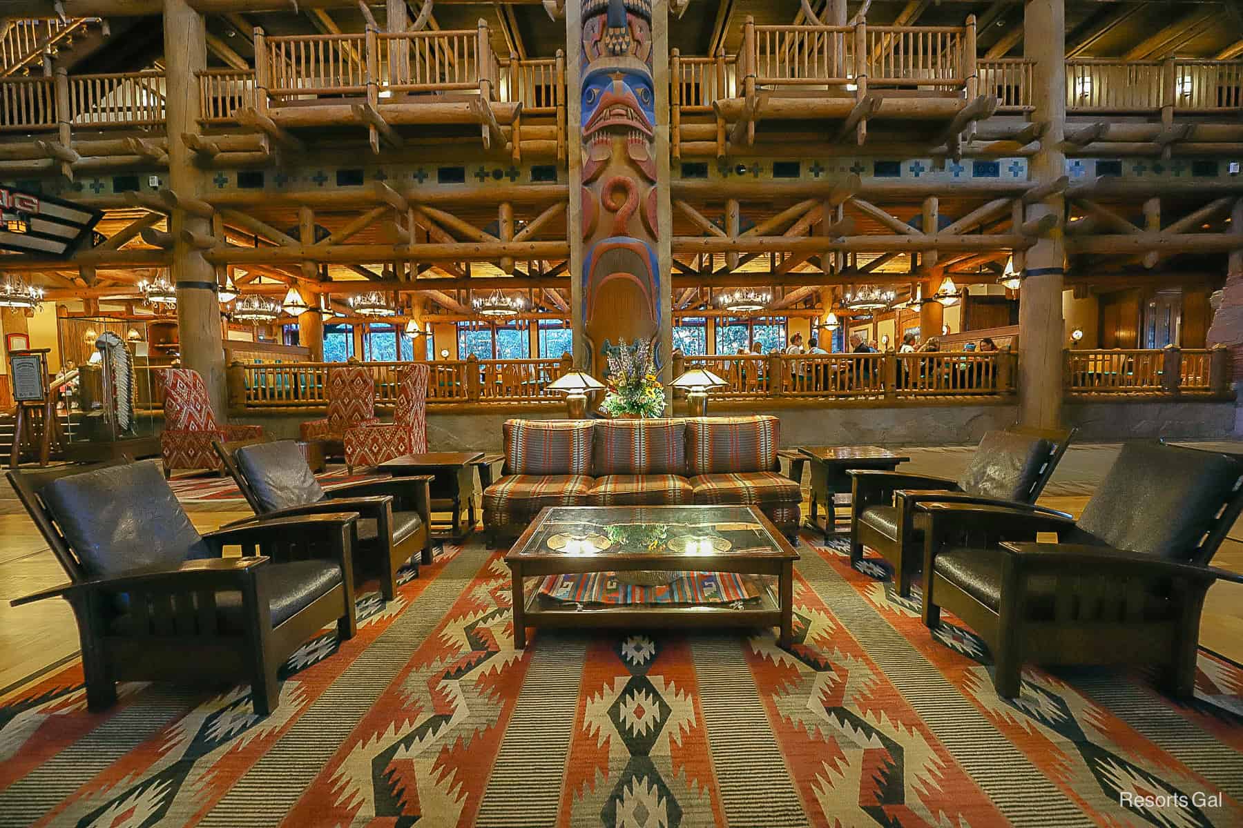 a sofa with chairs and a coffee table setting in the lobby 