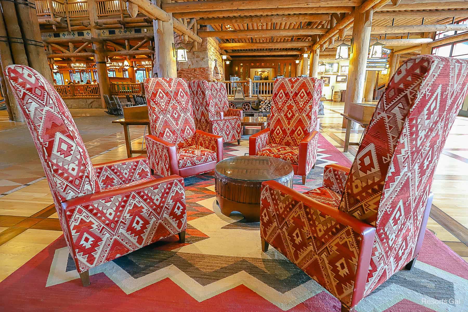 rows of nestled tall red chairs with high backs in the Wilderness Lodge lobby 