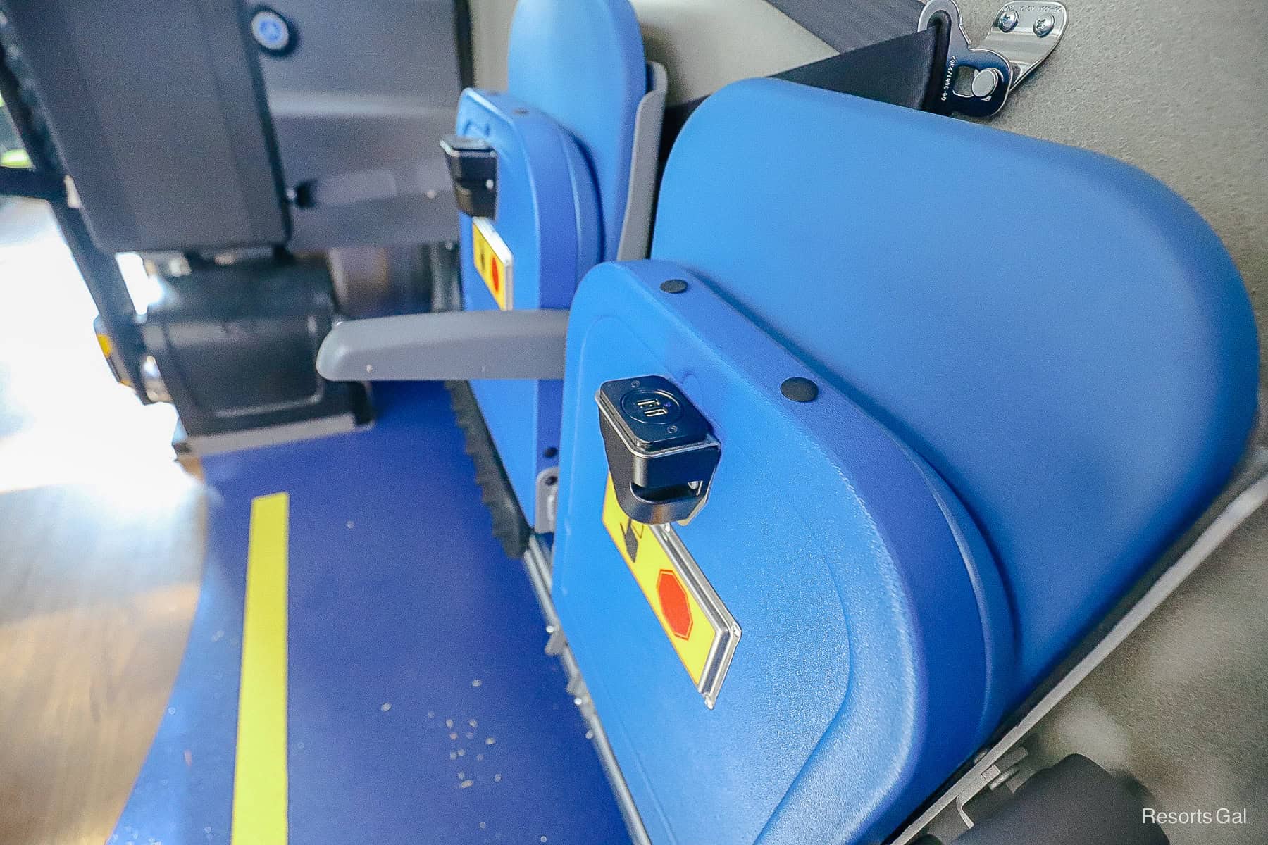 shows the outlet charging under the seats of a Disney World bus 