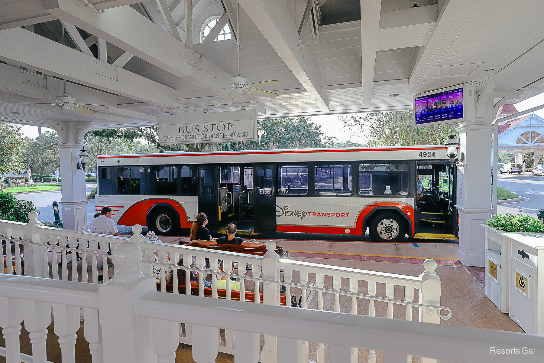 guests waiting on a bench at the resort bus stop 