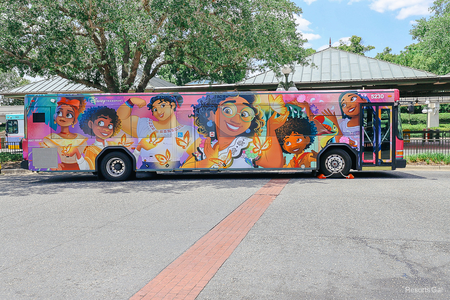 an Encanto themed bus picking up guests at Walt Disney World 