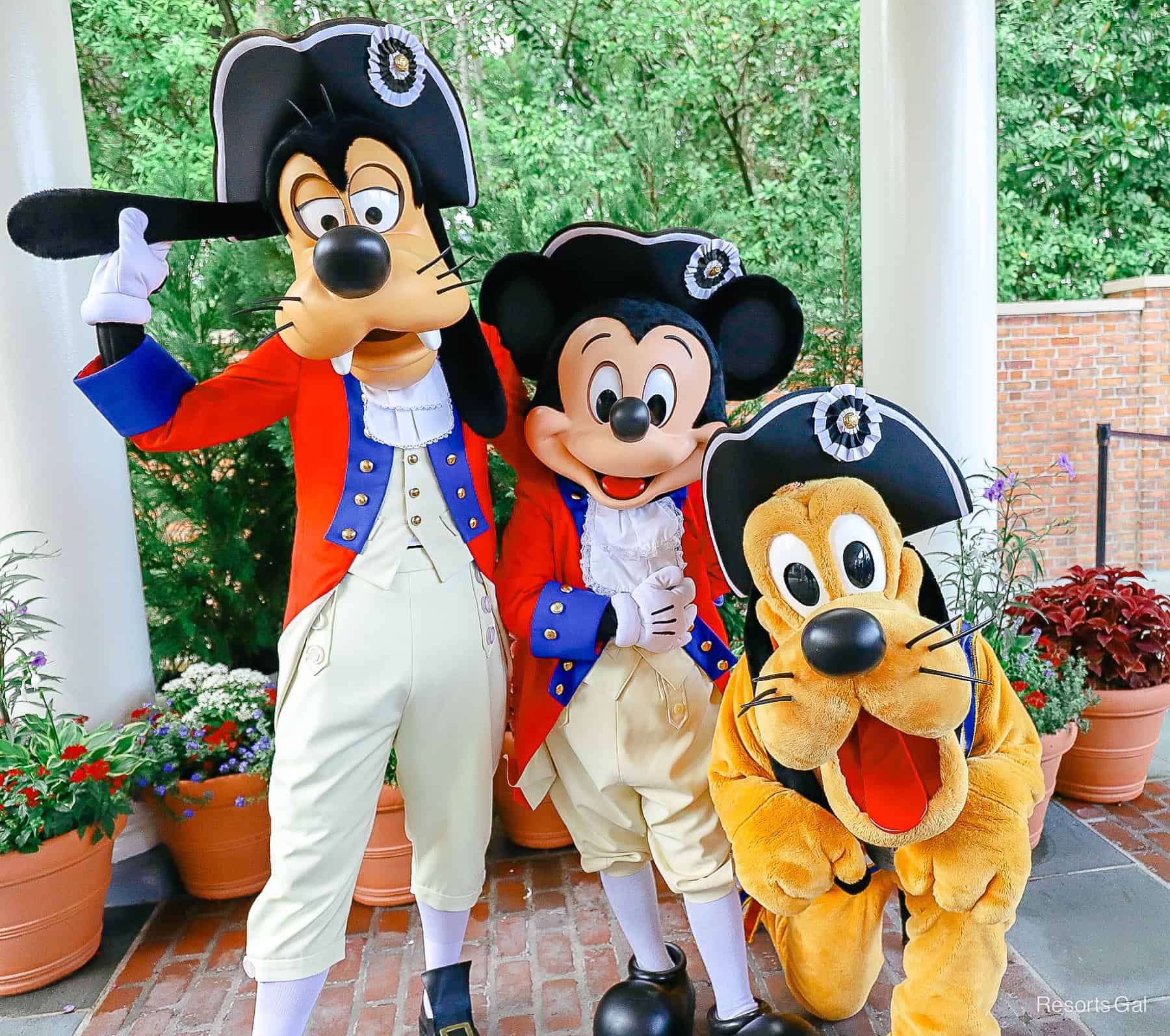 Mickey Mouse, Goofy, and Pluto in patriotic costumes at Epcot on the 4th of July 