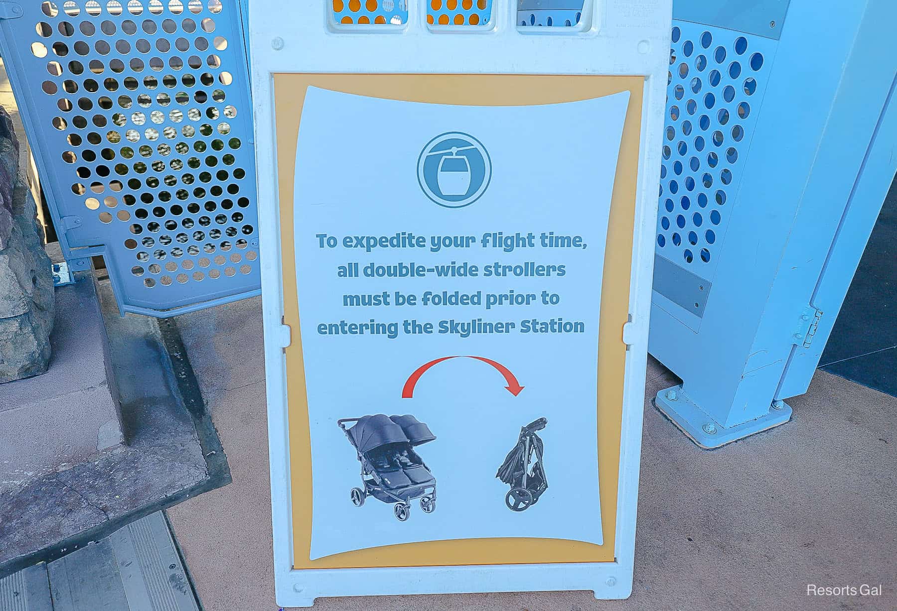 a sign that shows how guests with double wide strollers must fold them prior to entering the Skyliner station 