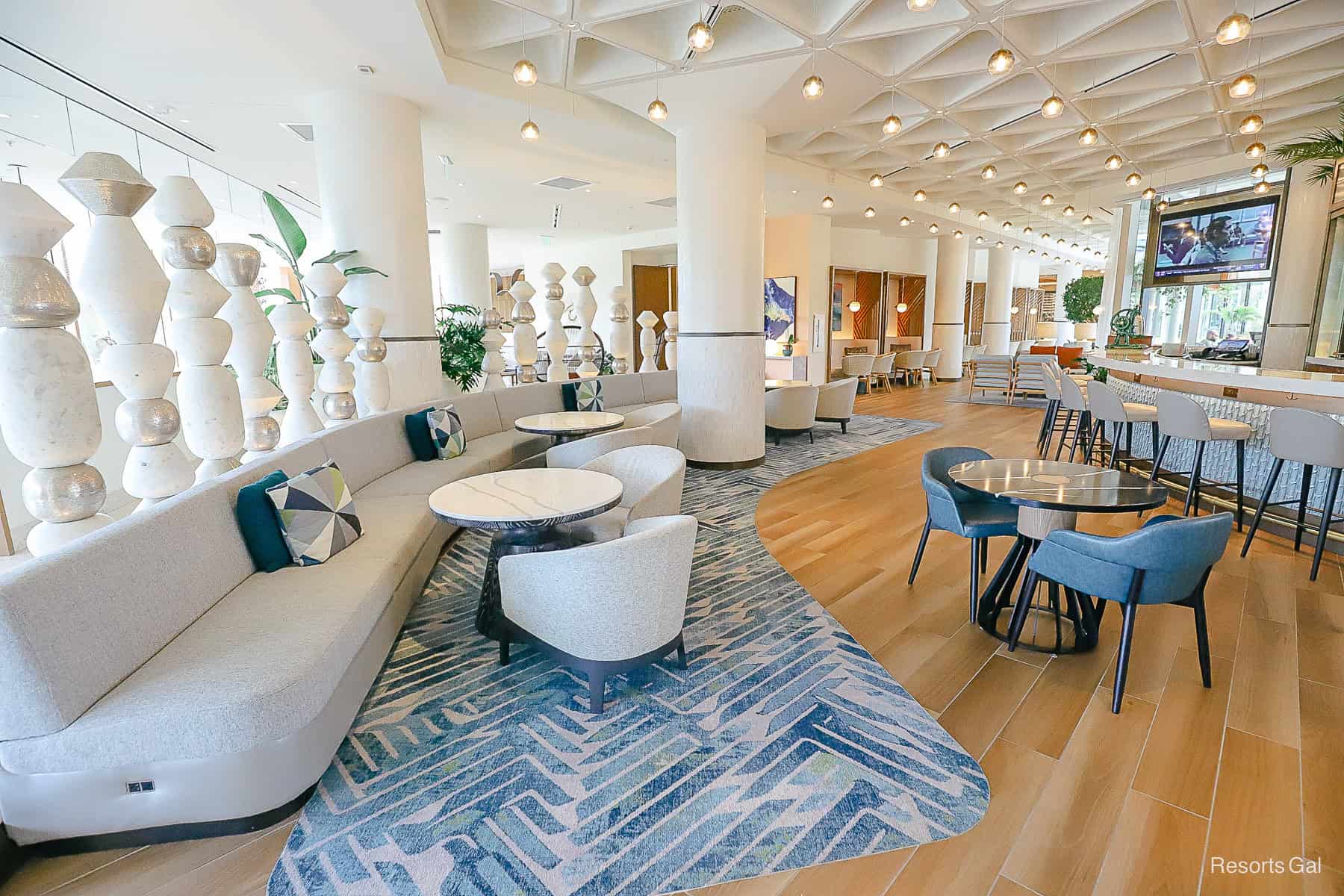 lounge seating area with light blues and grey in the Swan Reserve Hotel at Disney 