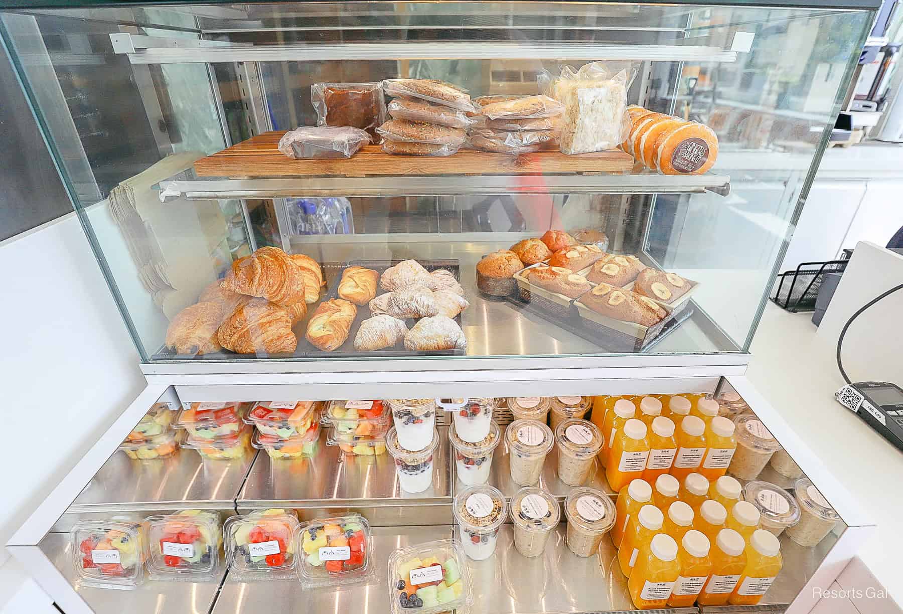 a case with pastries, croissants, banana bread, cookies, parfaits, and freshly squeezed juice at the Swan Reserve 