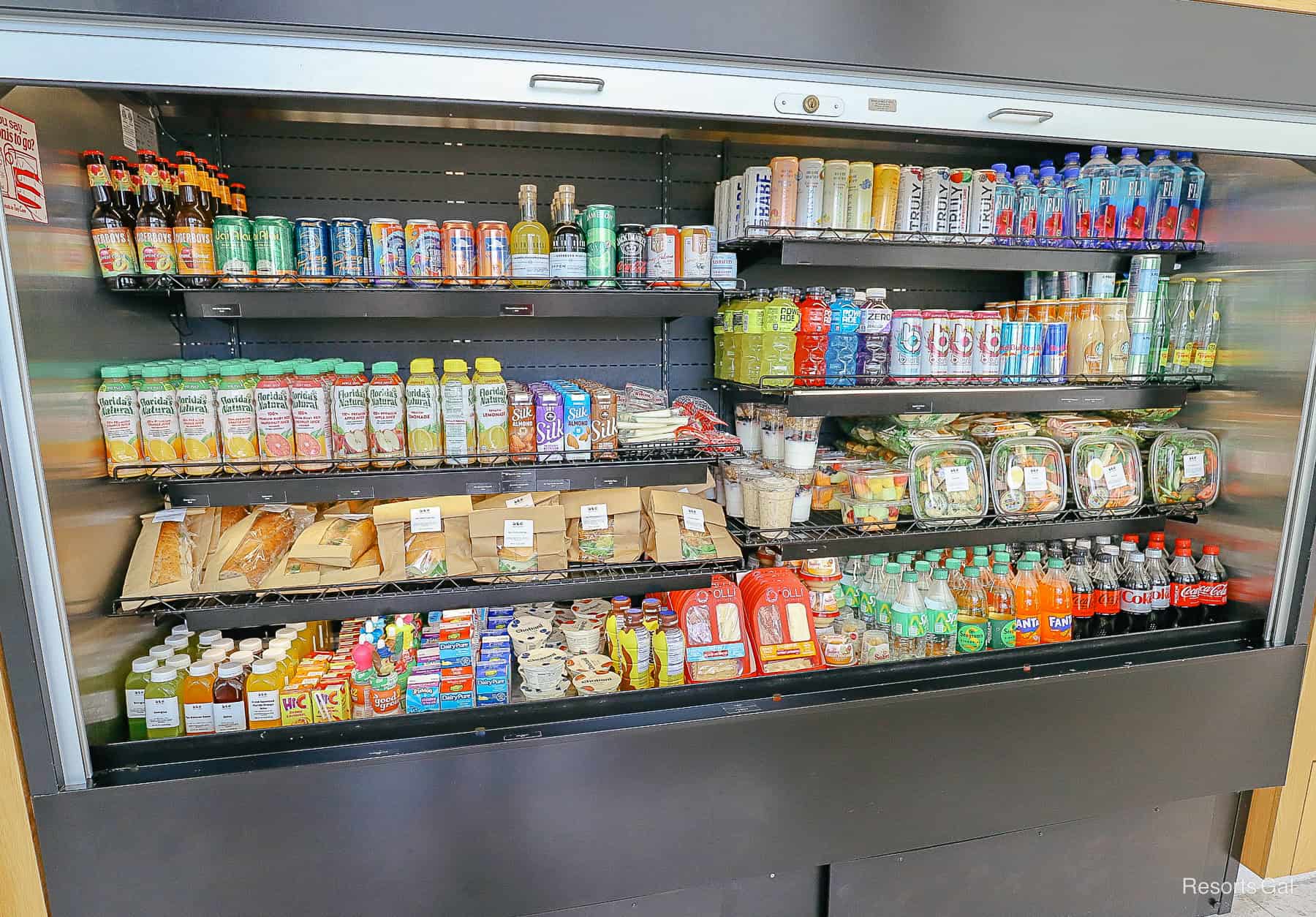 a refrigerated case with a variety of cold food items at the hotel's quick service 