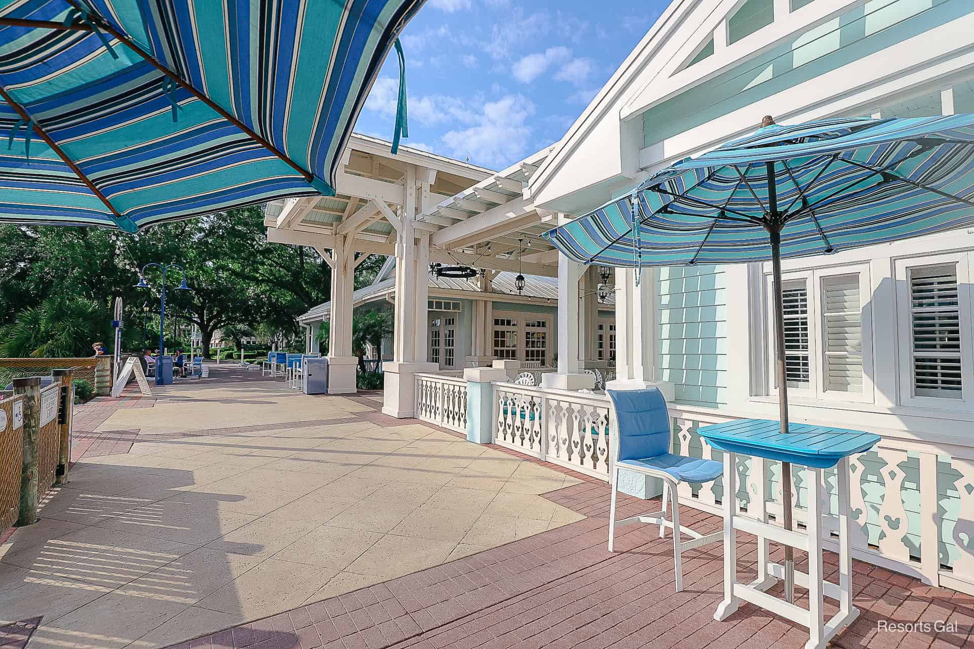 small tables and chairs with umbrellas at Hospitality House 