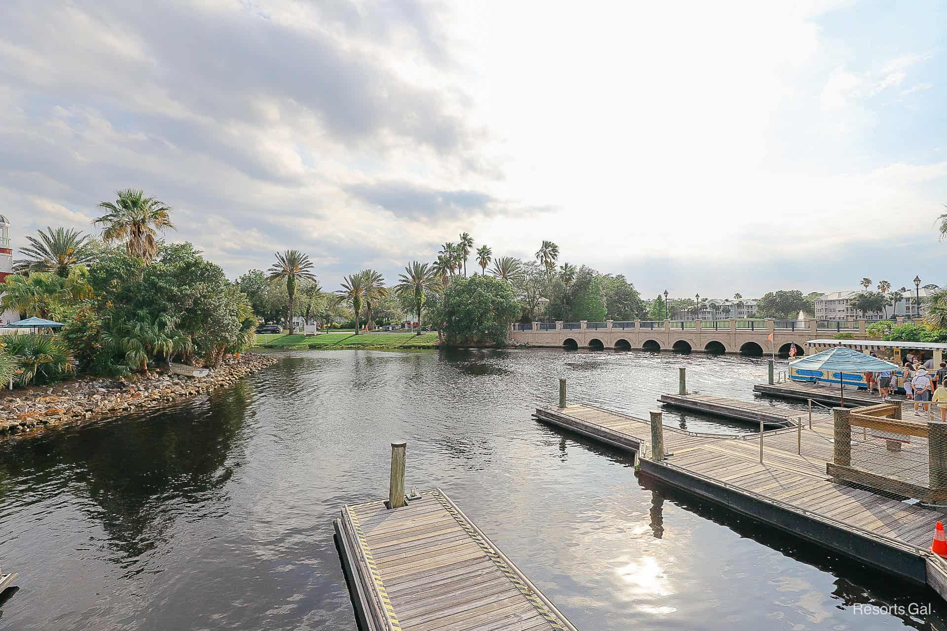 a view of the water where guests arrive via boat service and the resort bridge just beyond it 