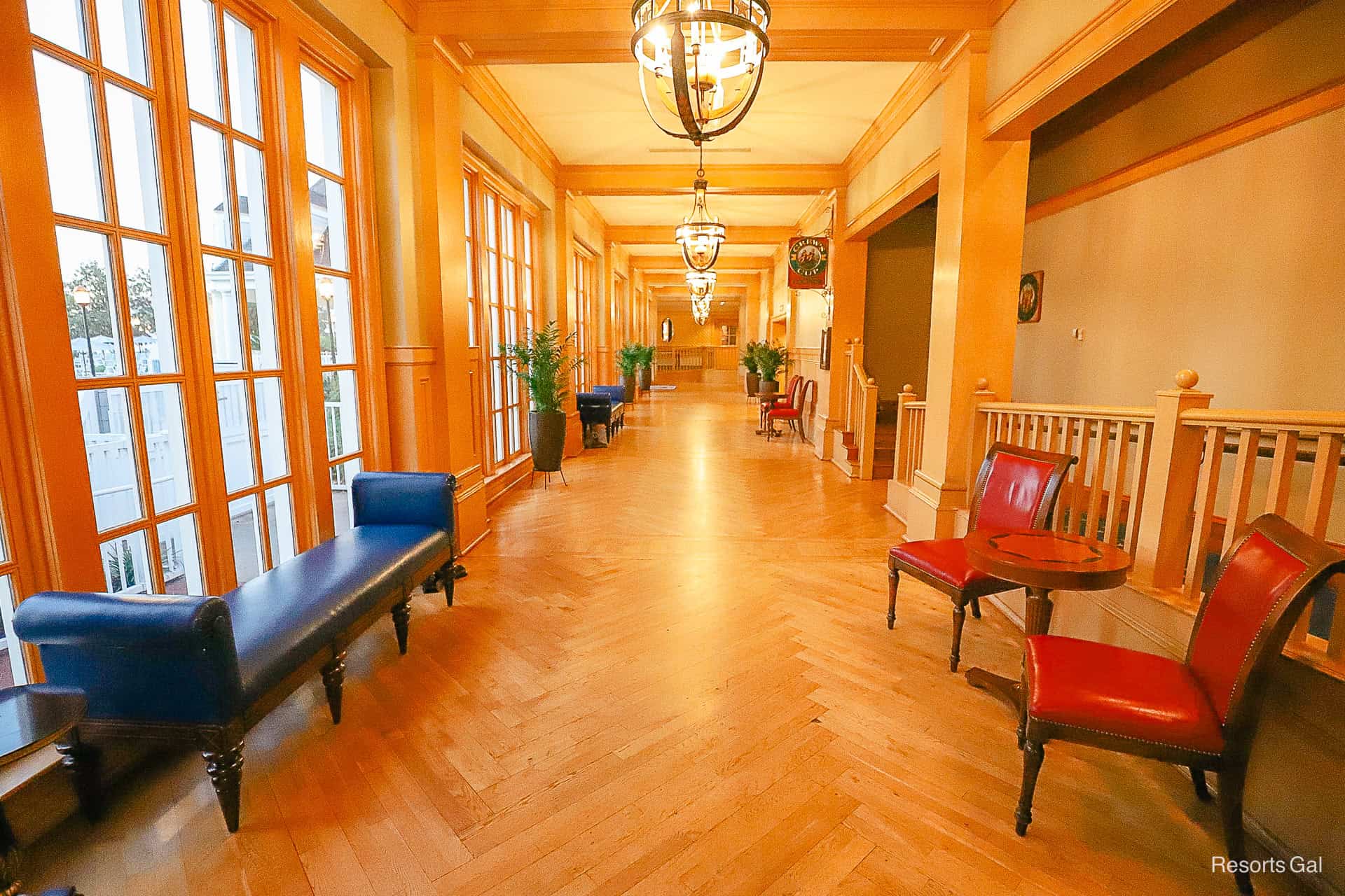 a row of blue leather benches and red chairs for guests to sit 