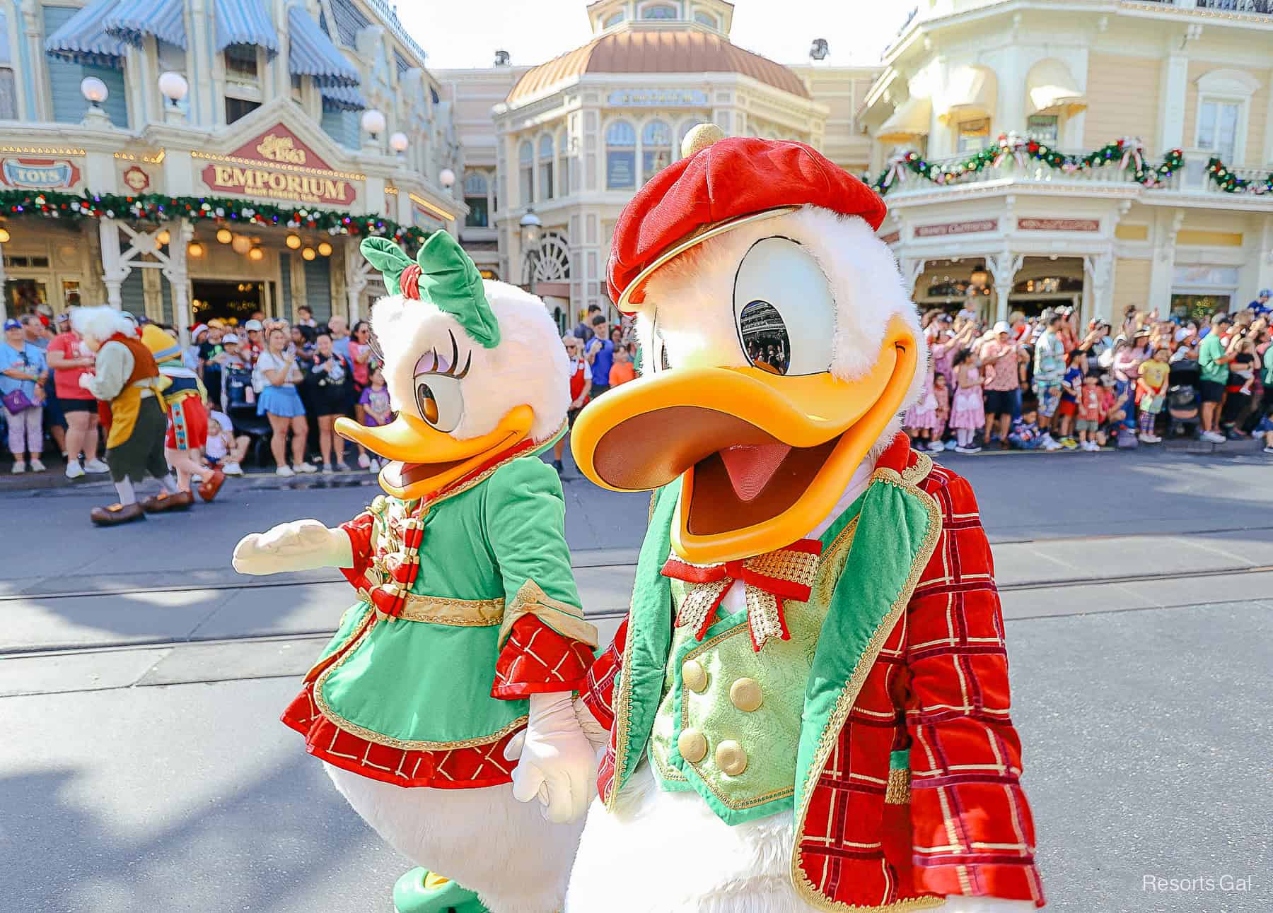 Donald wearing a read hat and Christmas outfit in the parade. 