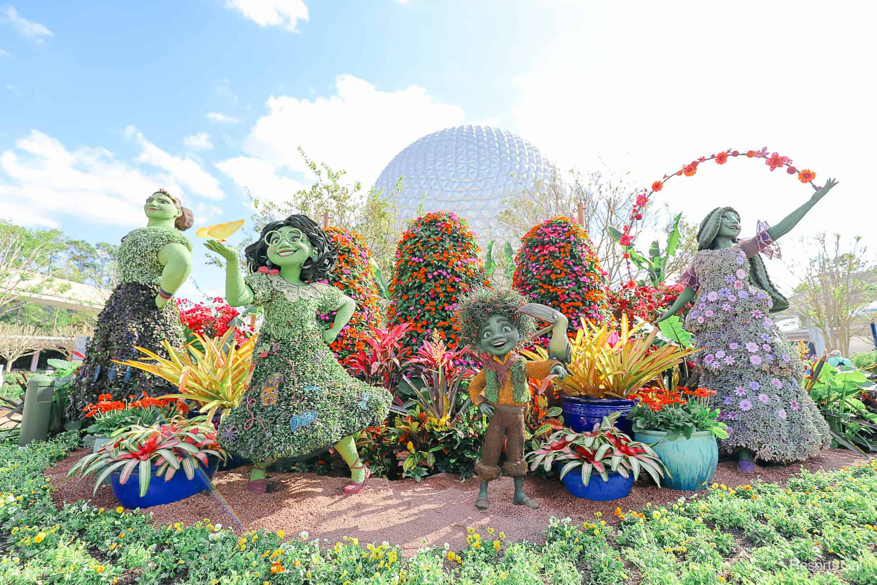 full view front and center of the Madrigal siblings left to right Luisa, Mirabel, Antonio, and Isabela in topiary form 