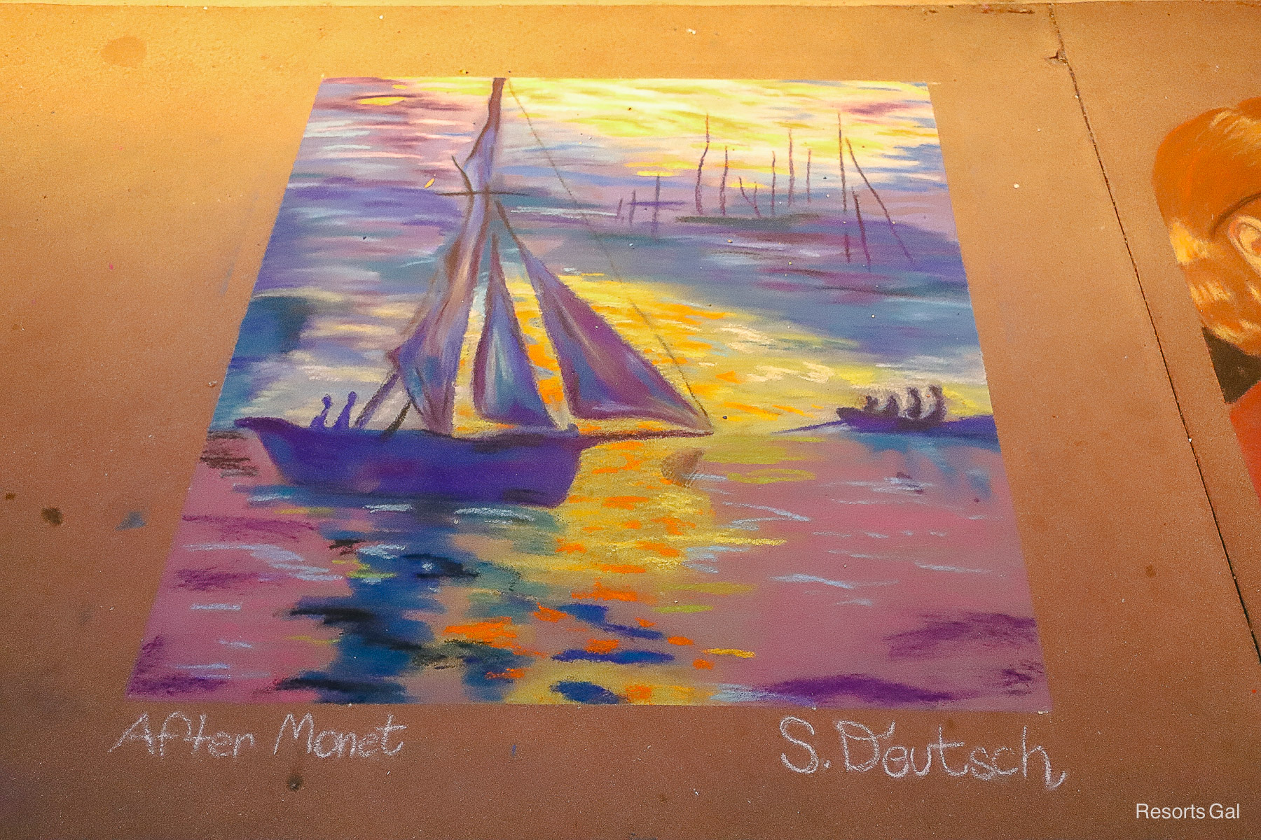 a drawing of a boat on the water created with chalk 