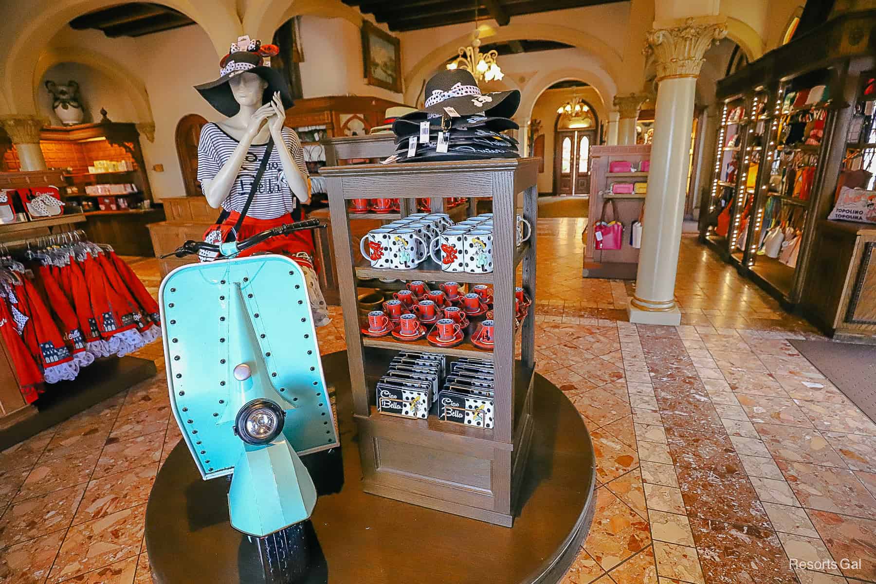 a display in the Italy Pavilion gift shop with a mannequin riding a Moped 