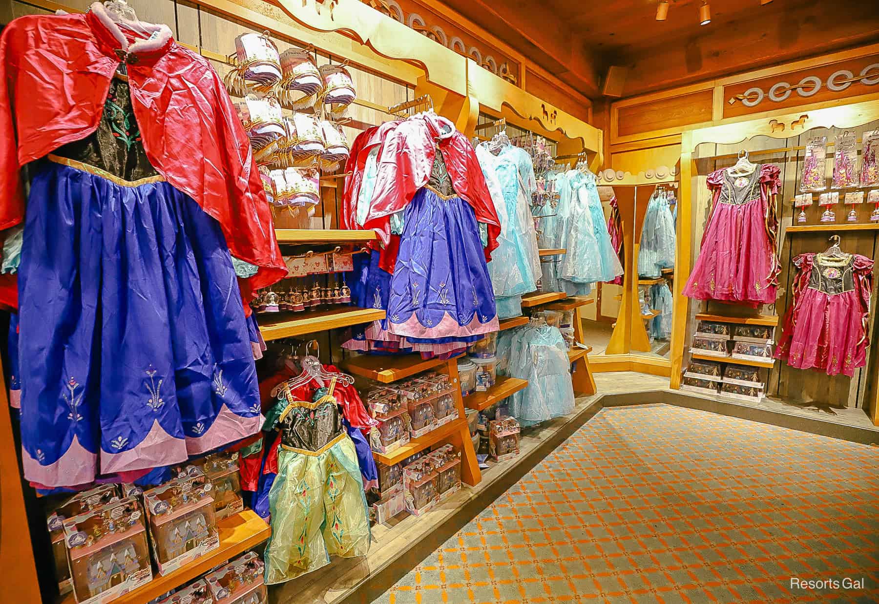 a display featuring Frozen merchandise with dresses and costumes in the Norway Pavilion 