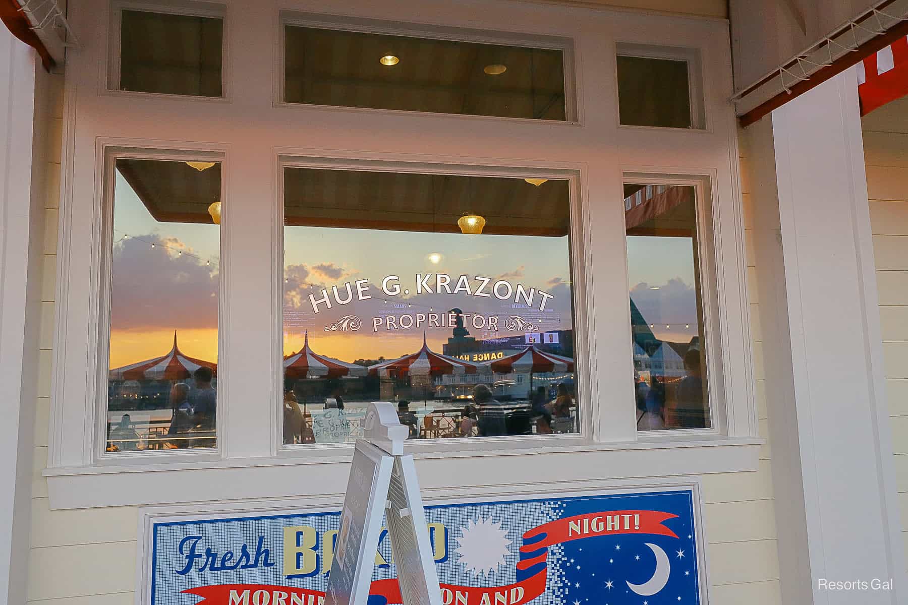 a reflection of the sunset in the window of the Boardwalk Deli 