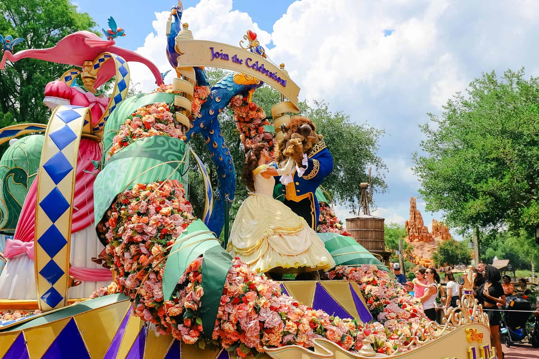 Beauty and Beast dance on the first float in the parade. 