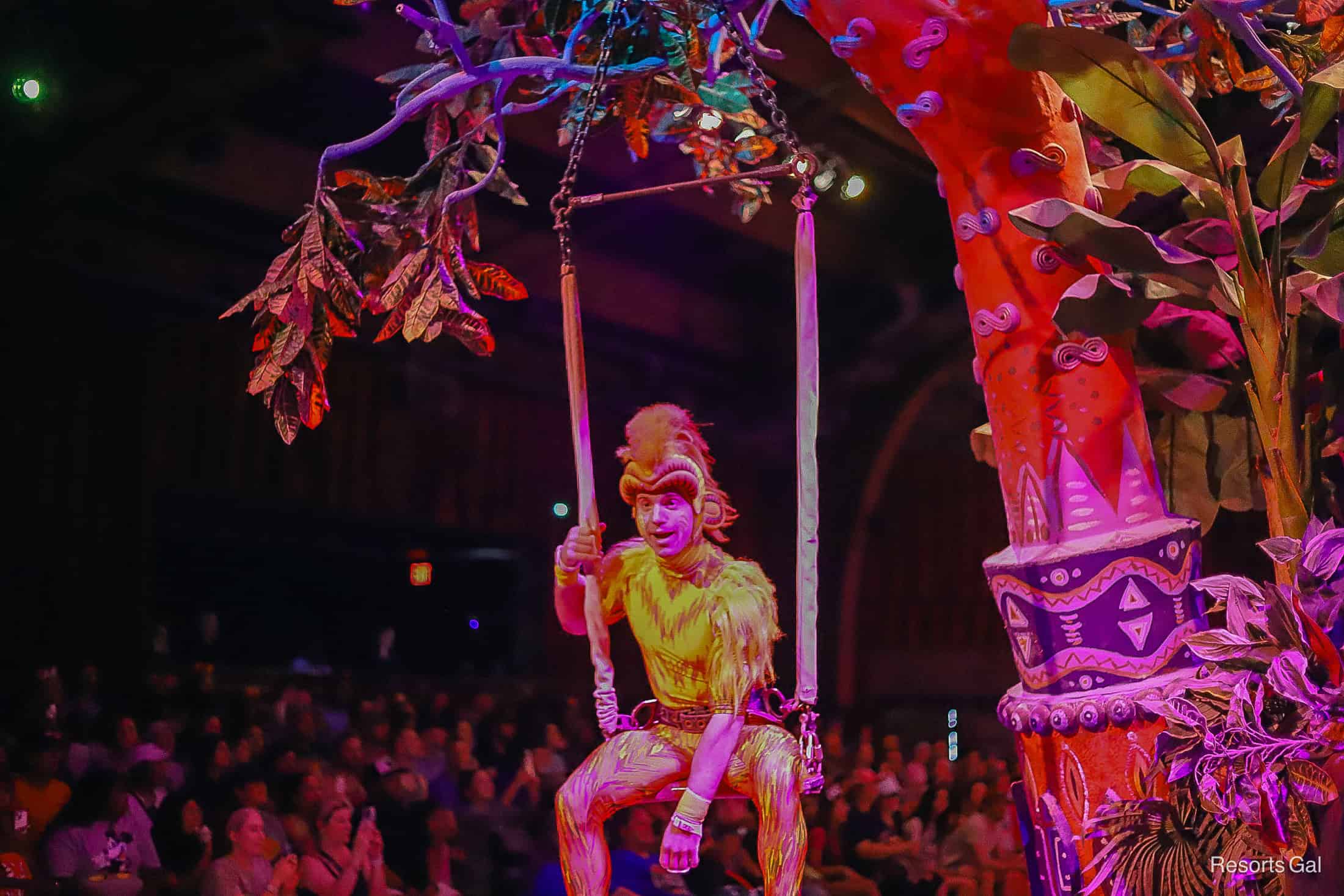 a tumble monkey acrobat swinging from a tree float in Festival of the Lion King 