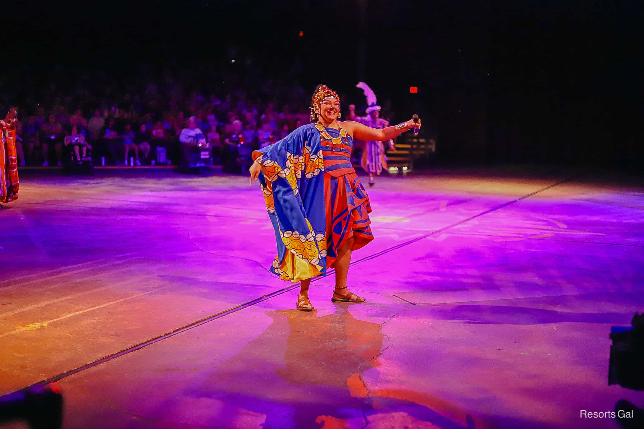 a performer wearing traditional African dress in Festival of the Lion King 