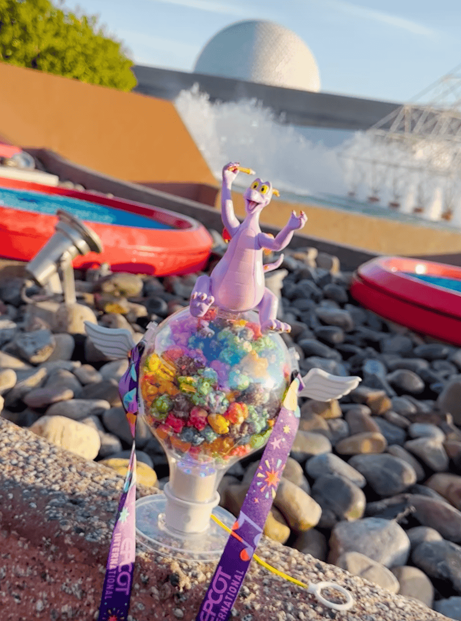 the Figment Popcorn bucket with pull string filled with rainbow popcorn 