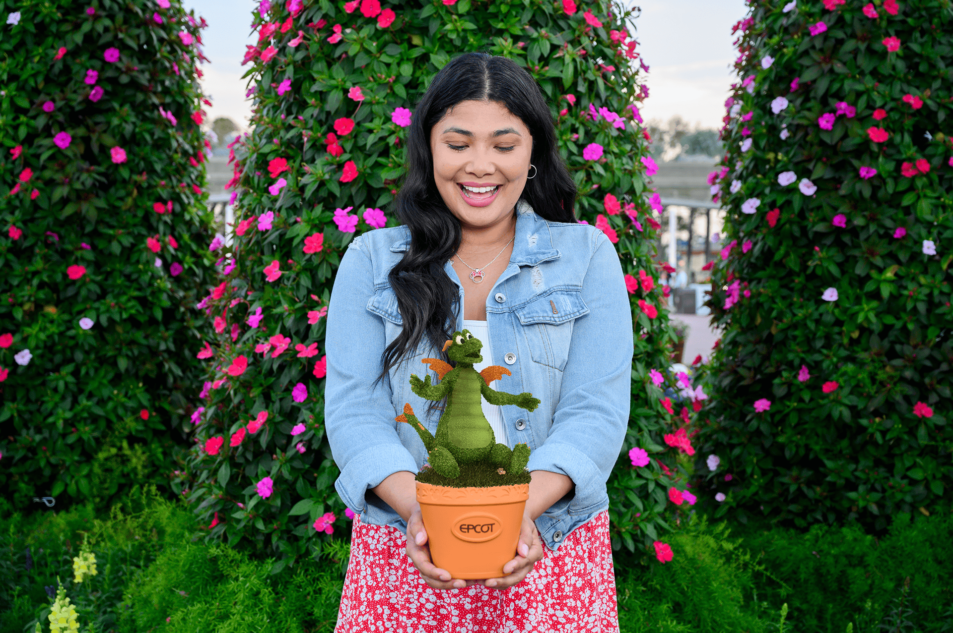 a guest holding a mini potted plant with a Figment topiary 