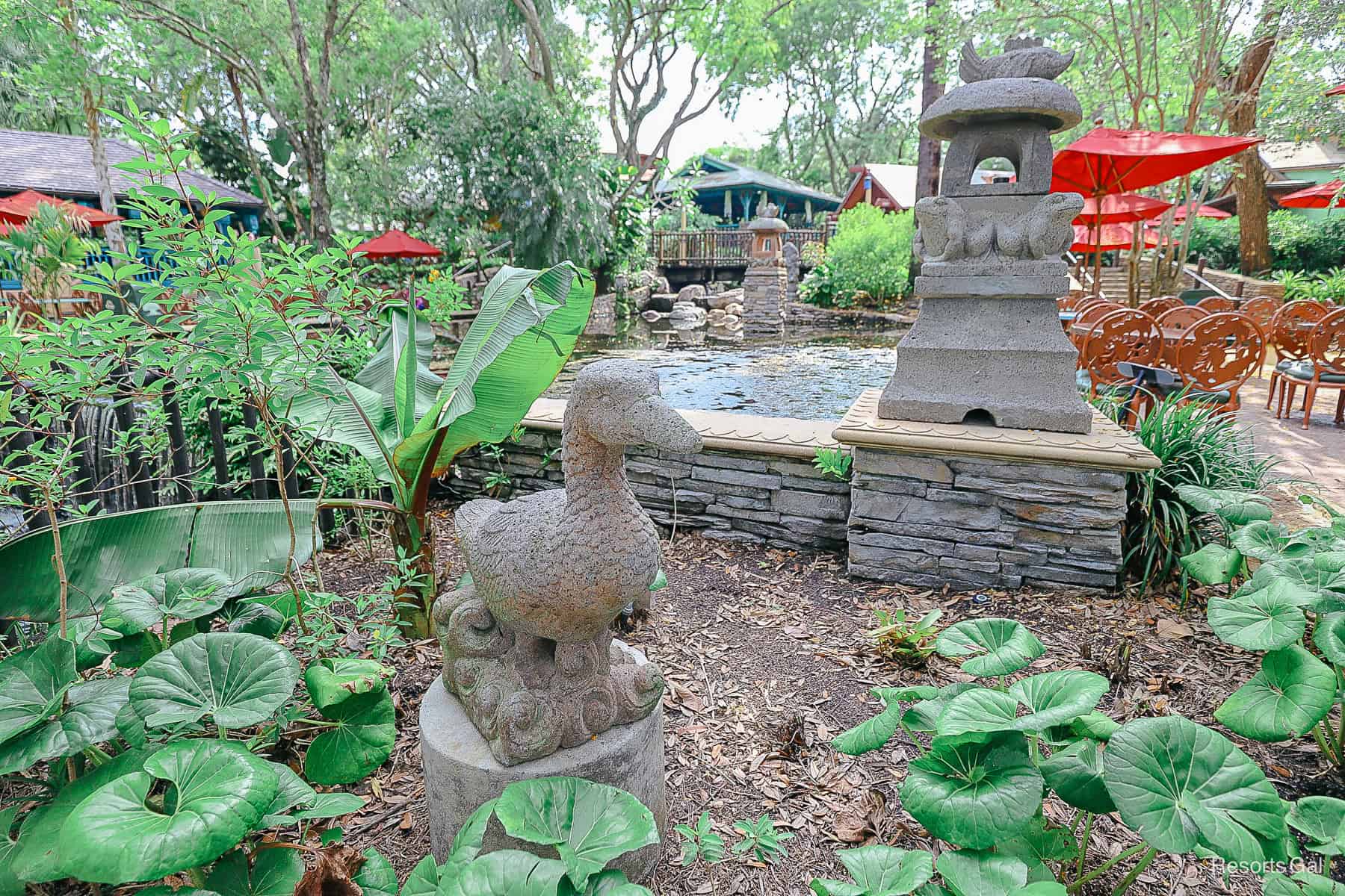 a statues with a duck near a pond at Flame Tree BBQ 