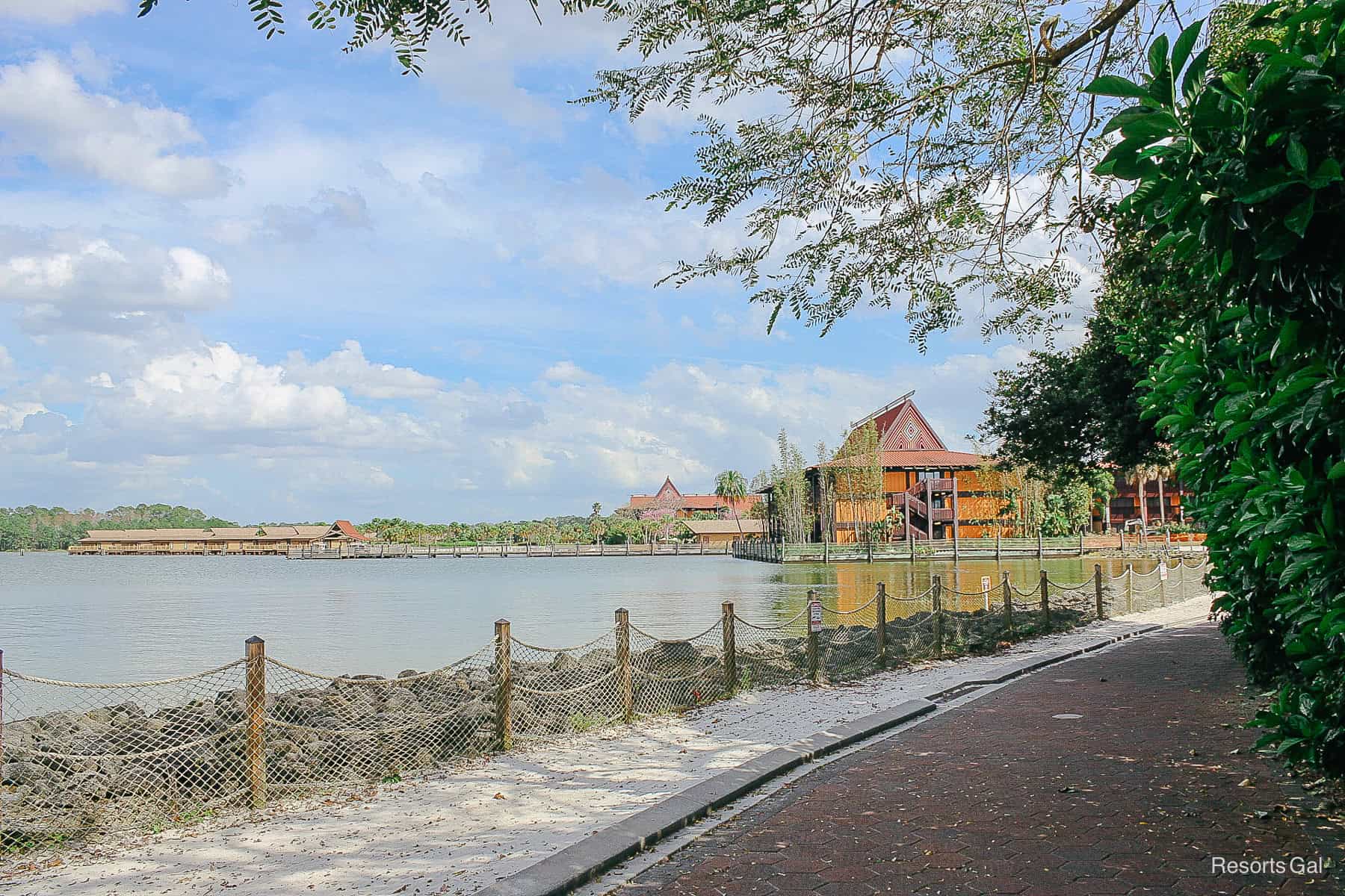 a view of the Polynesian with the bungalows on the water from the walking path 