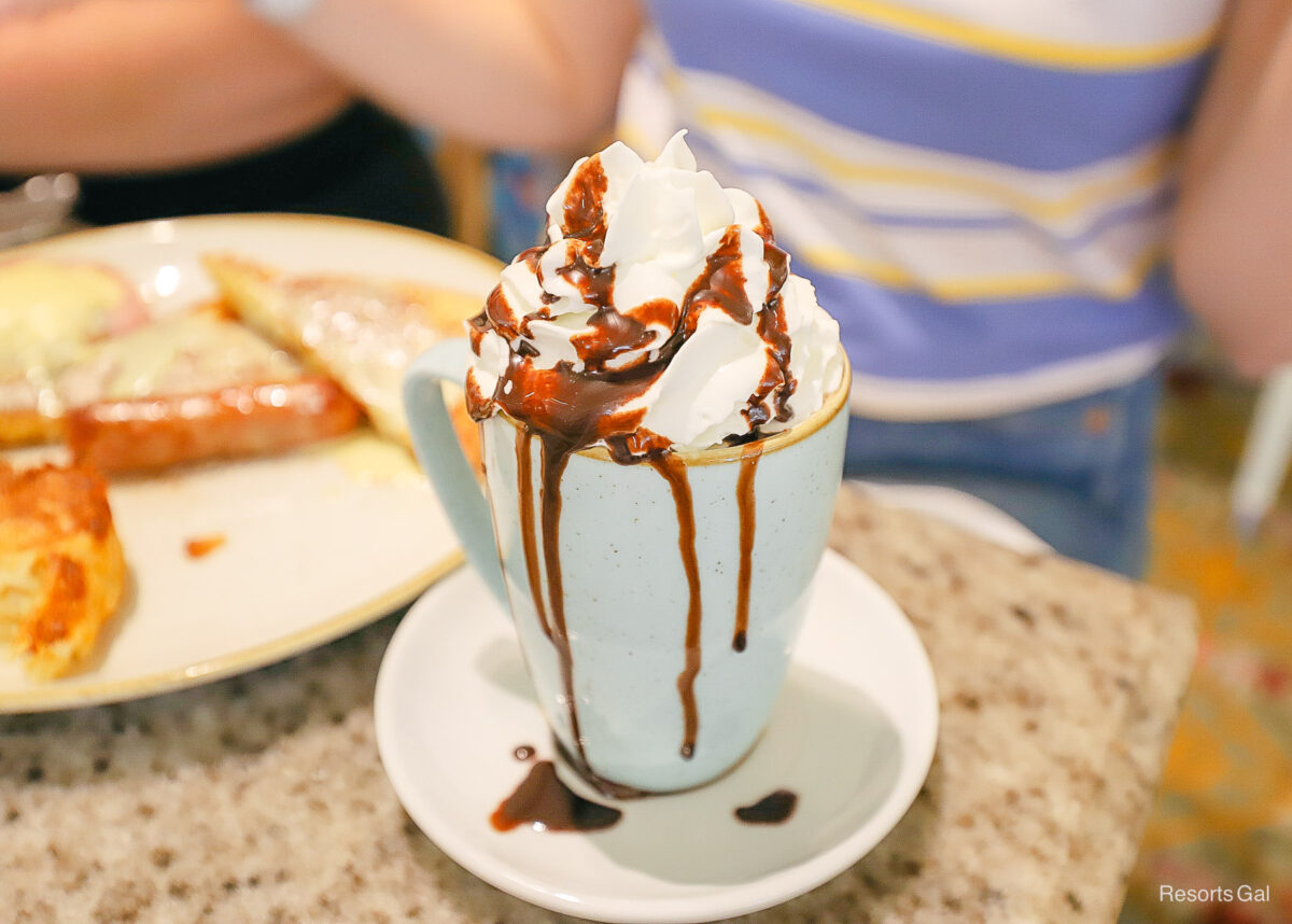 a specialty coffee drink from Grand Floridian Cafe topped with whipped cream and chocolate 