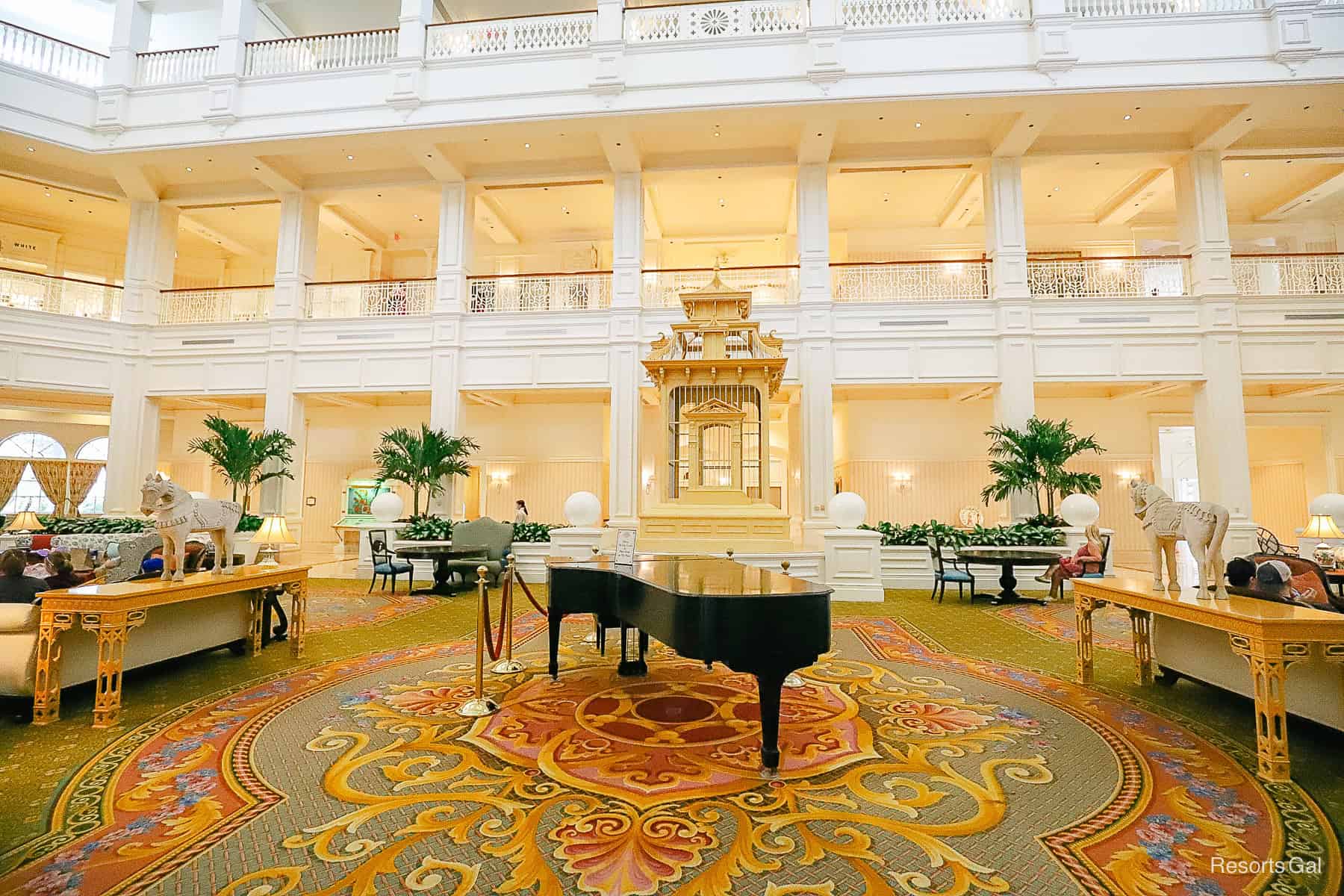 a piano sits in front of a bird cage in the Grand Floridian lobby