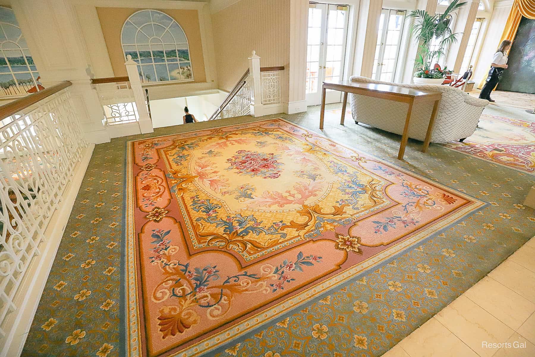 a rectangle carpet design at the top of the stairs 