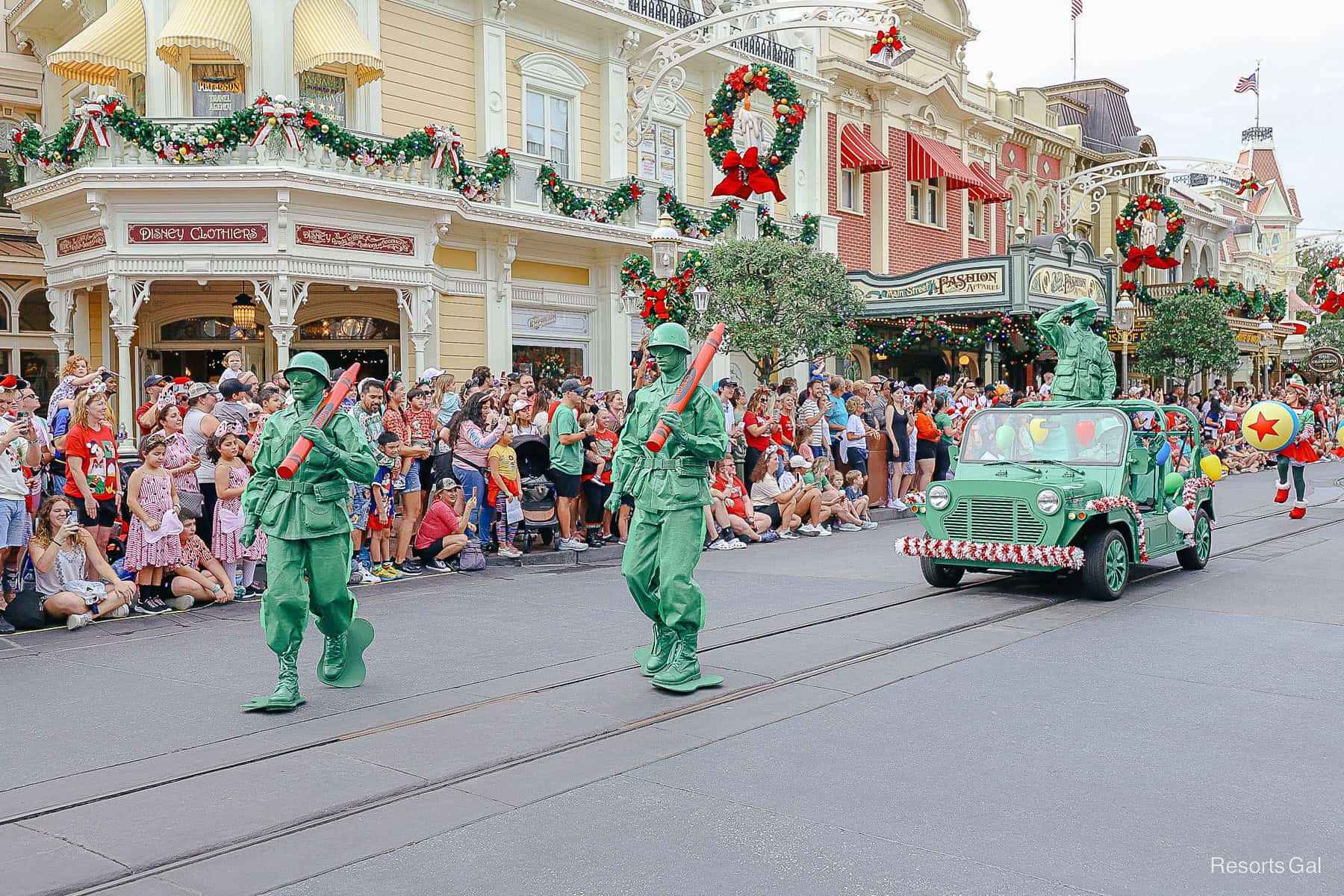 Two Green Army Men carrying red crayons in the Christmas Parade at Magic Kingdom. 