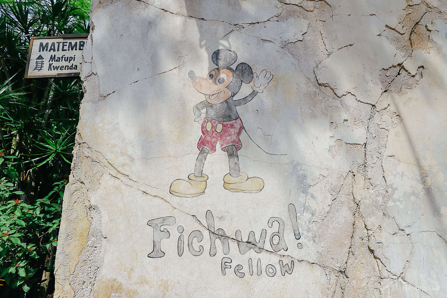A not so hidden Mickey mural waves. The mural reads Fichwa Fellow. 