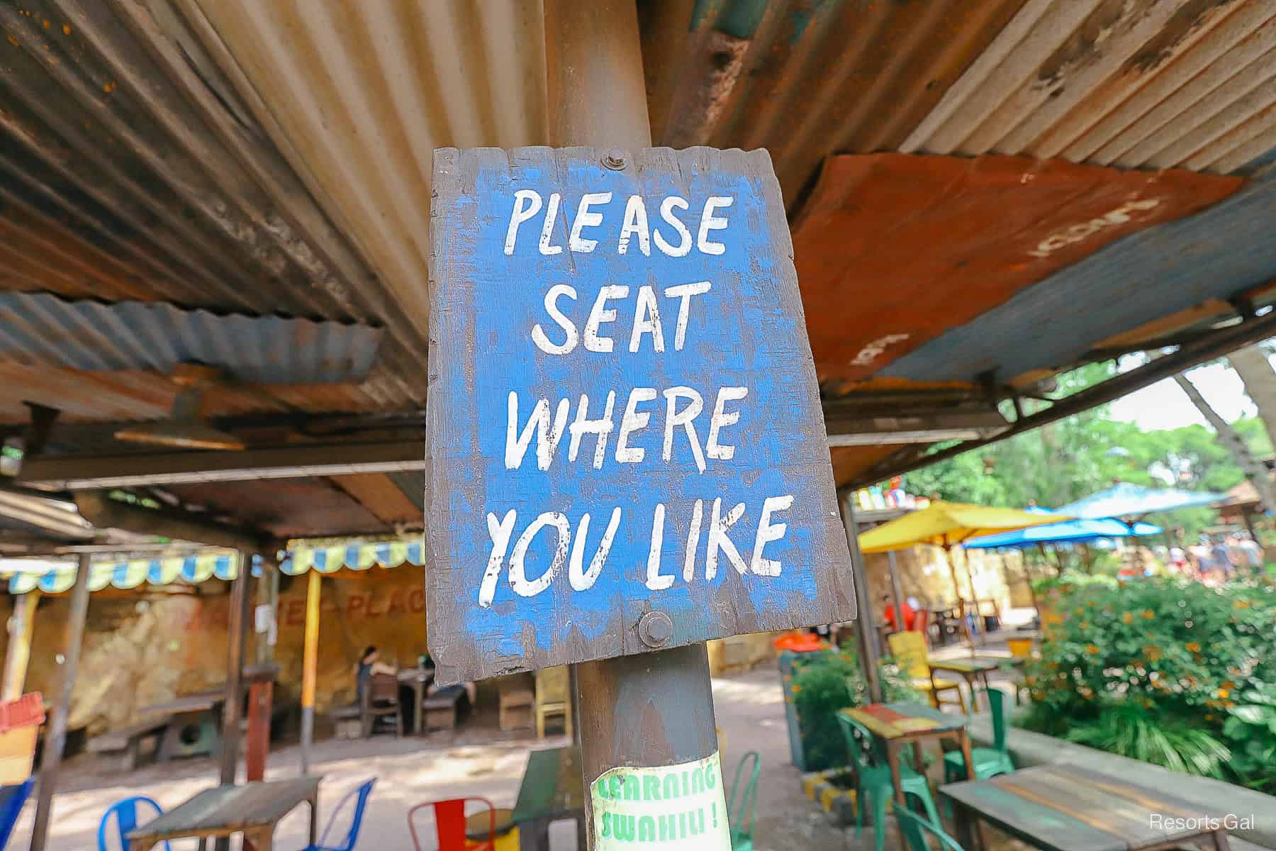 a sign that reads "Please Seat Where You Like" 