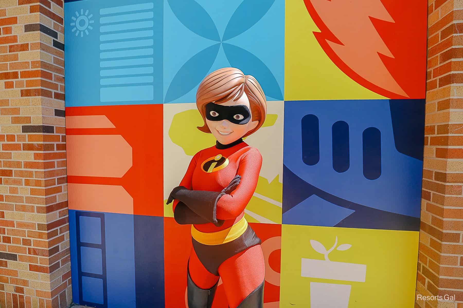 Elastigirl poses for a photo against a Pixar-themed wall at Disney's Hollywood Studios. 