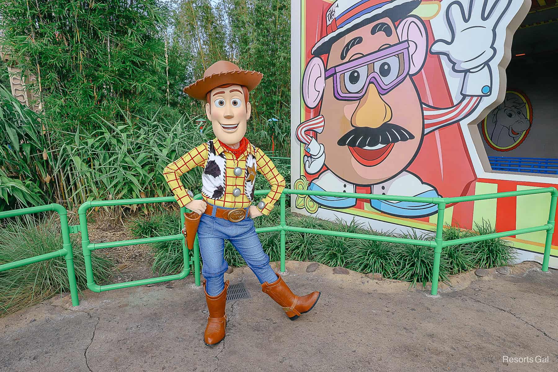 Woody poses in cowboy costume in front of Toy Story Mania at Disney's Hollywood Studios. 