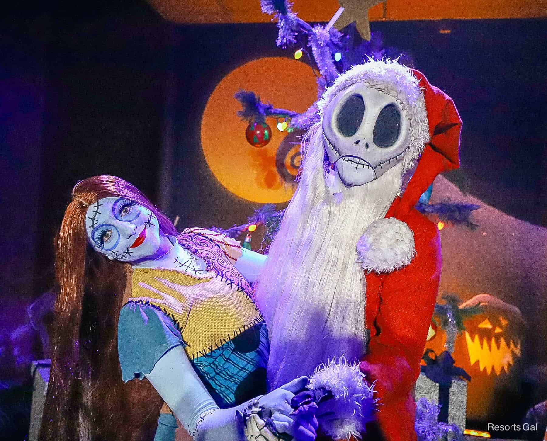 Sally and Jack Skellington in Sandy Claws costume pose for a photo at Mickey's Very Merry Christmas Party 