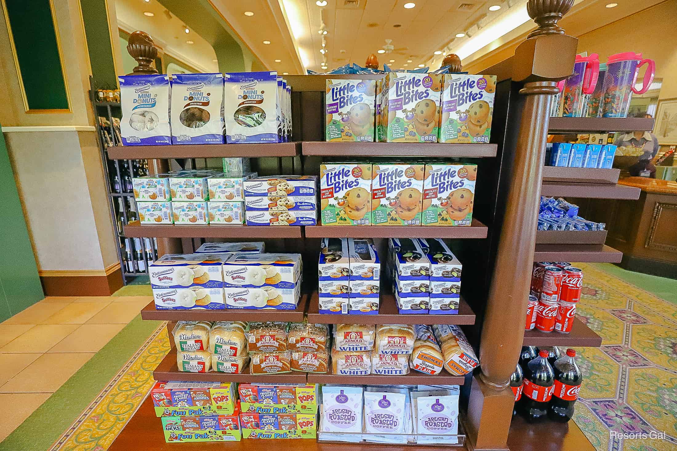 shelves with donuts, muffins, bread, and other grocery items 