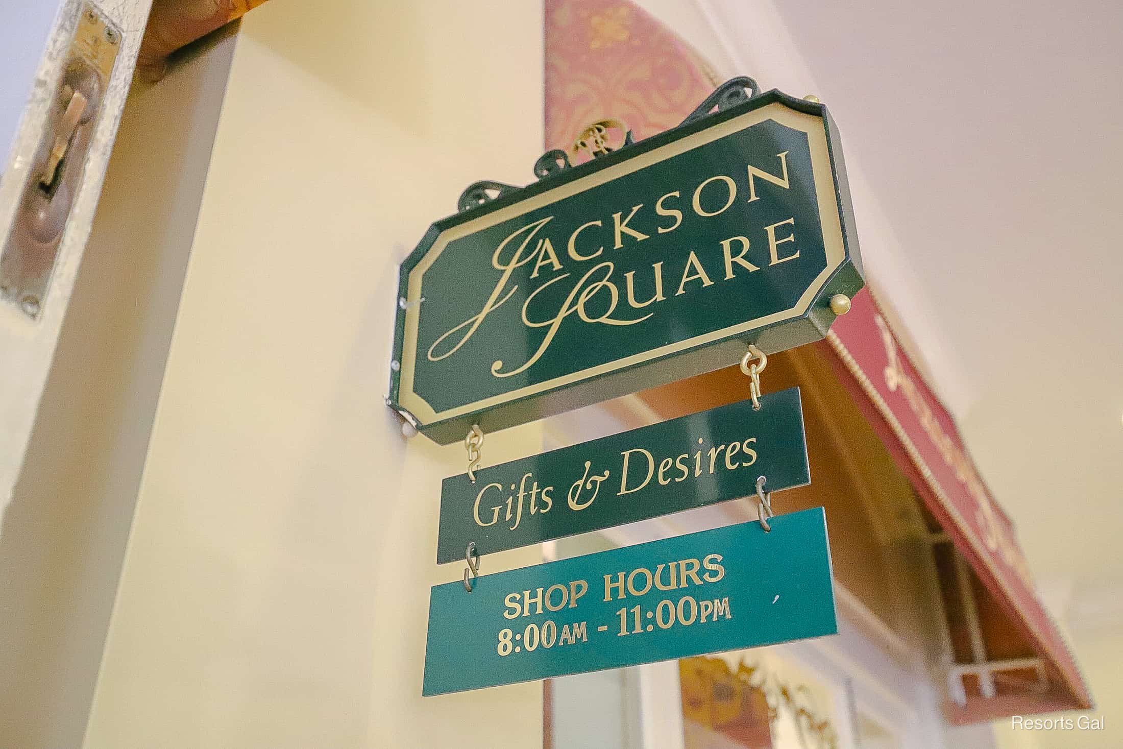 a sign that says Jackson Square Gifts and Desires Shop Hours 8:00 a.m. until 11:00 p.m.