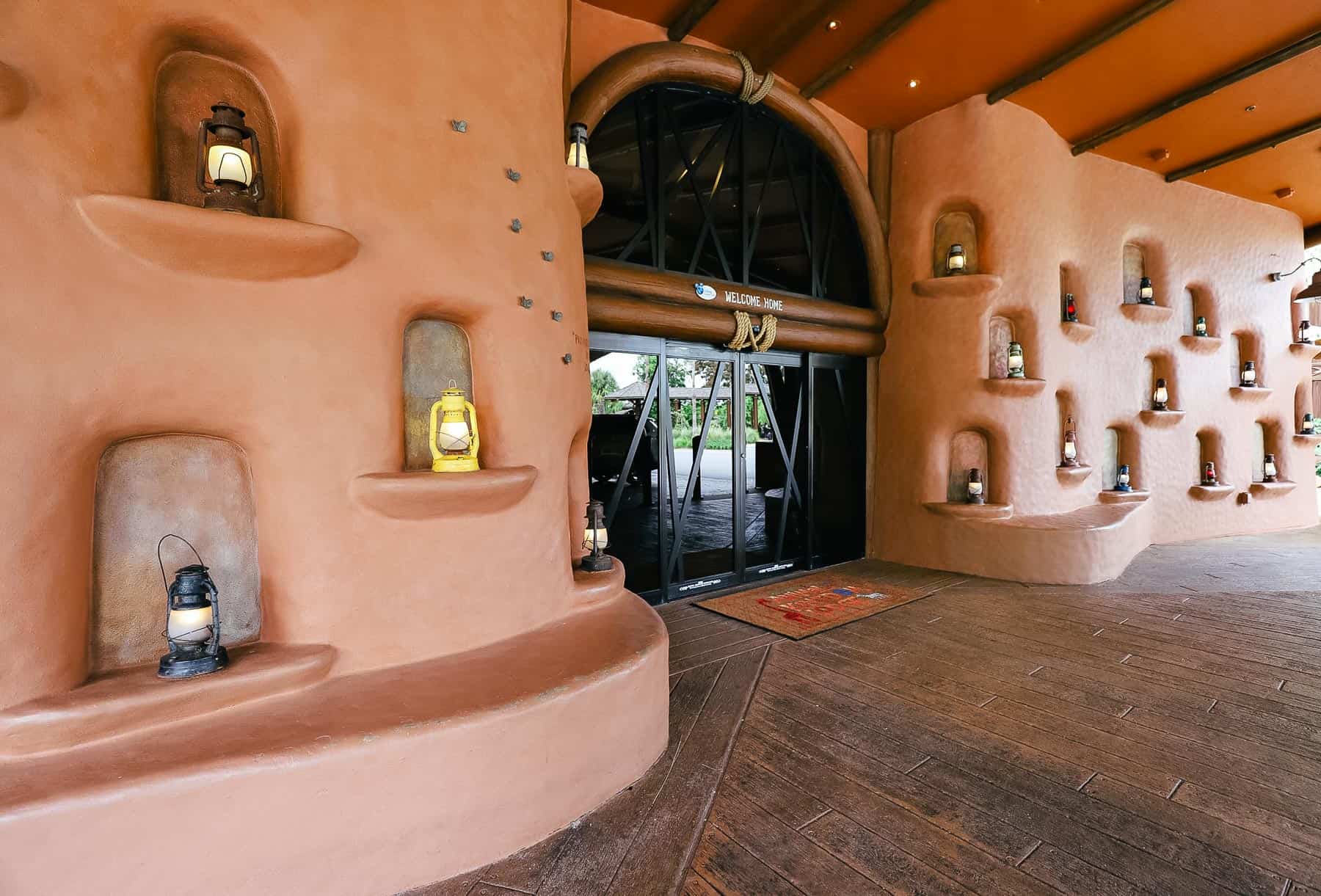 a wall of lanterns at the entrance of a hotel 