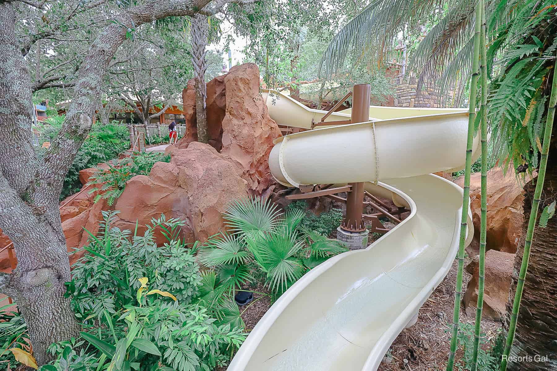 a twisted slide at a pool area 