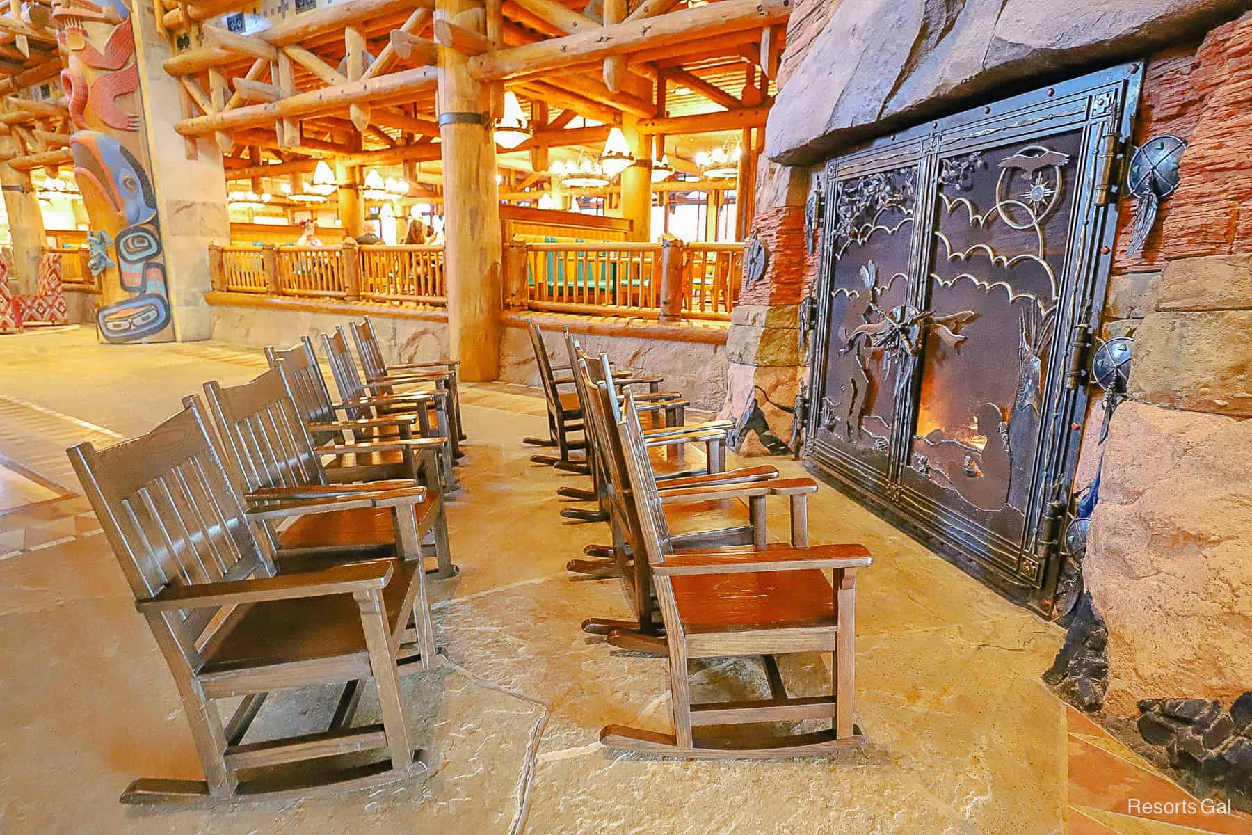 A grouping of rocking chairs near the fireplace. 