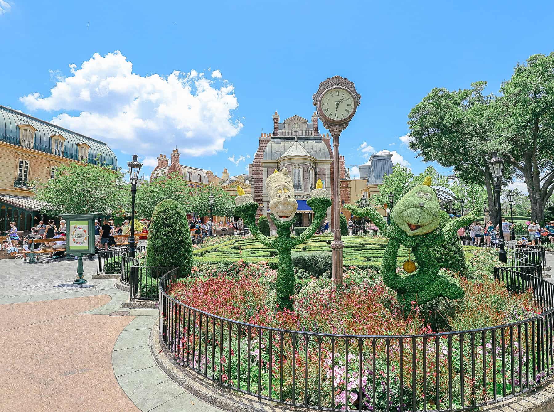 shows the placement of Lumiere and Cogsworth in front of the garden maze in Epcot's France Pavilion 