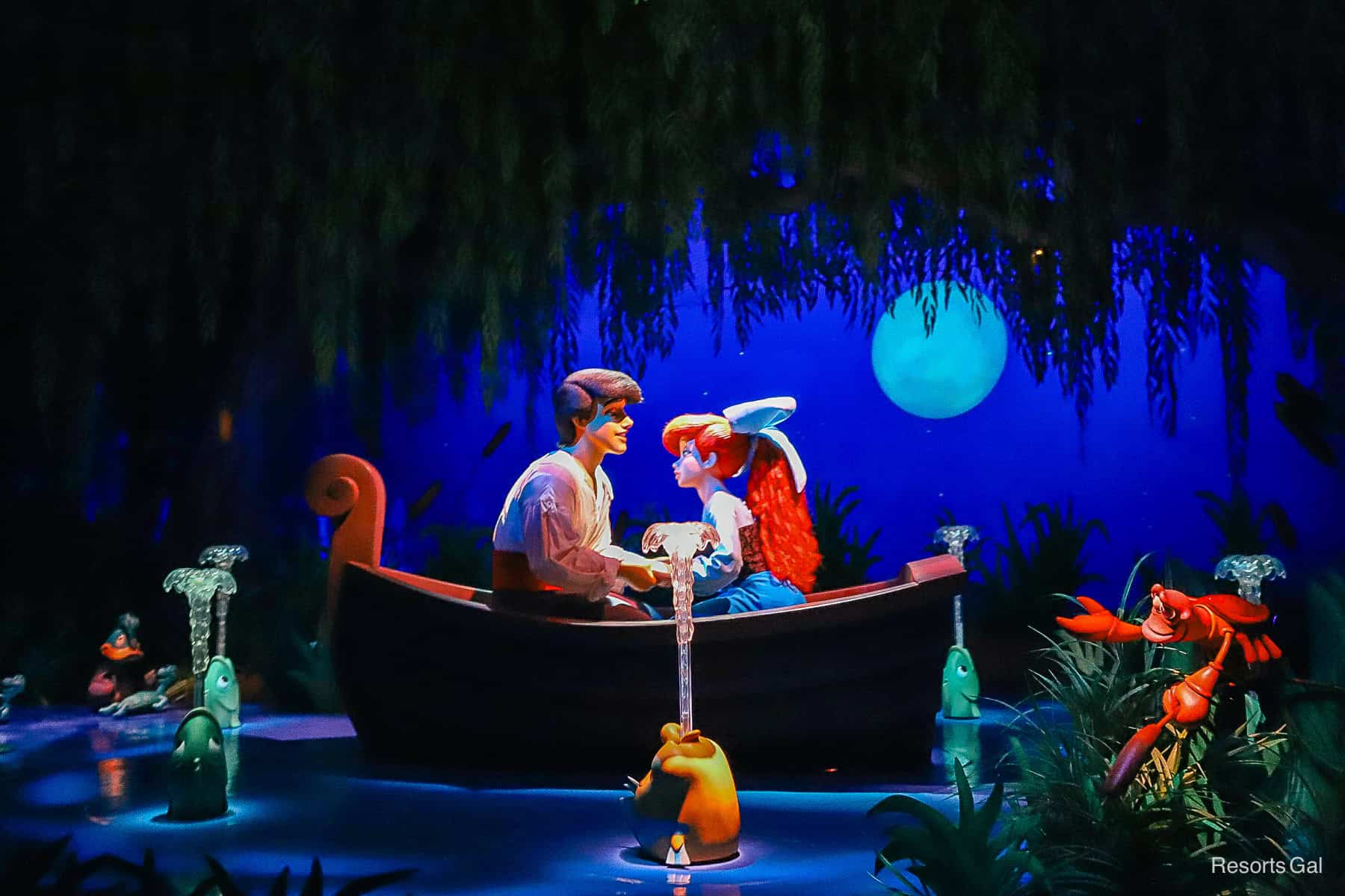 Eric and Ariel lean in for a kiss on a scene in the Journey of the Little Mermaid attraction at Magic Kingdom. 