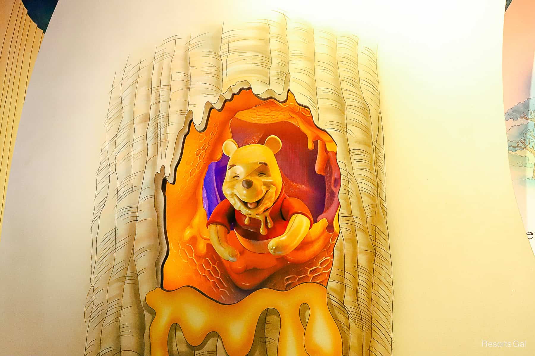 Pooh covered in honey on a scene of the Many Adventures of Winnie the Pooh attraction at Magic Kingdom 