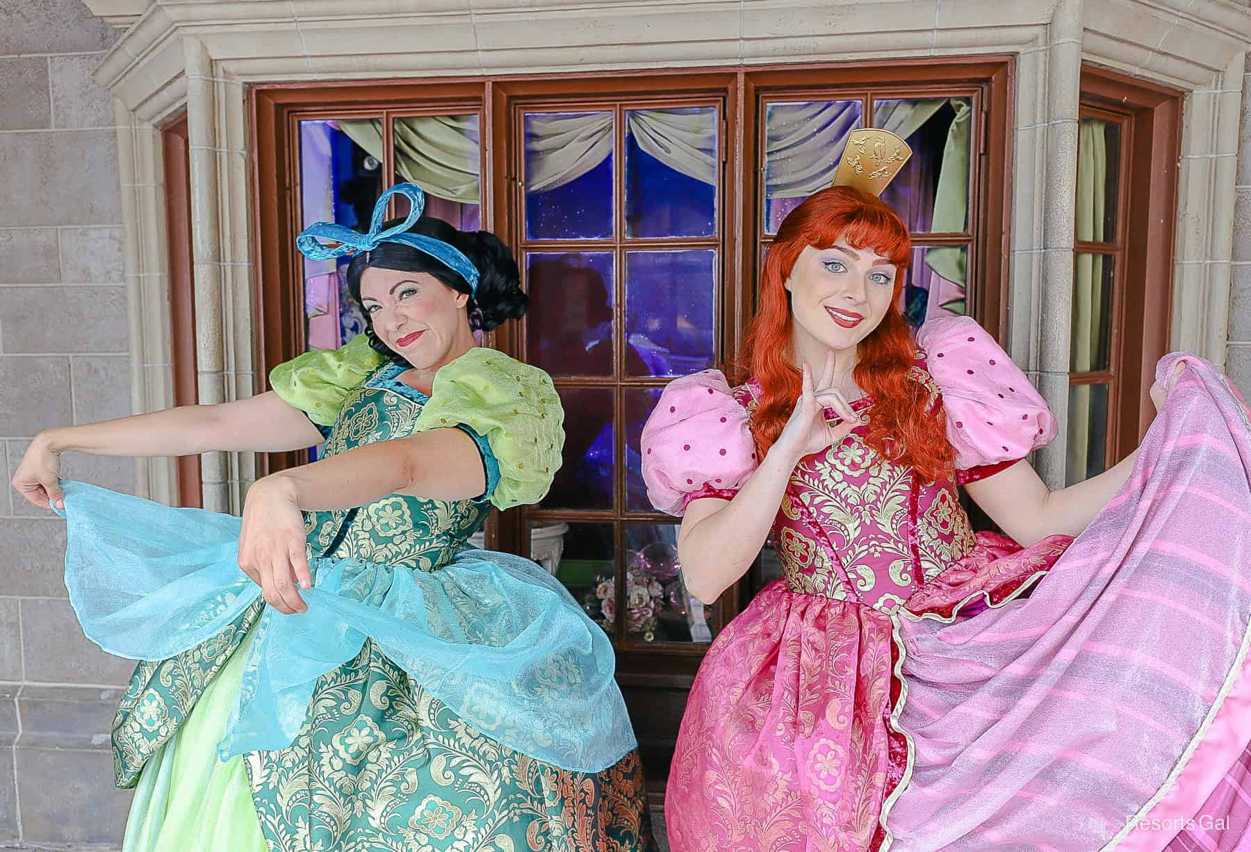 Anastasia in her pink dress and Drizella in her green dress at Magic Kingdom. 