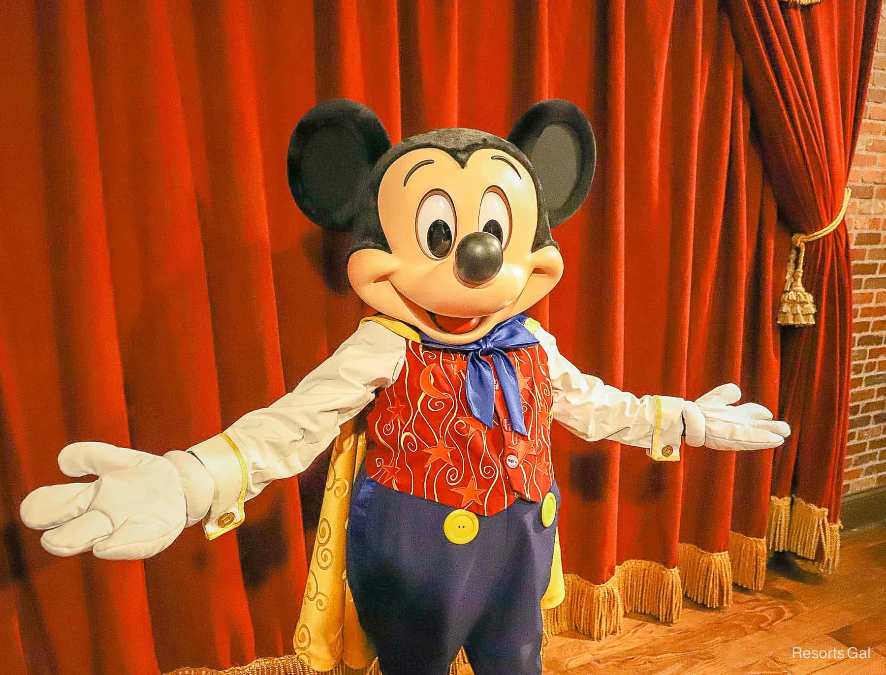 Mickey Mouse poses with widespread arms at Magic Kingdom 