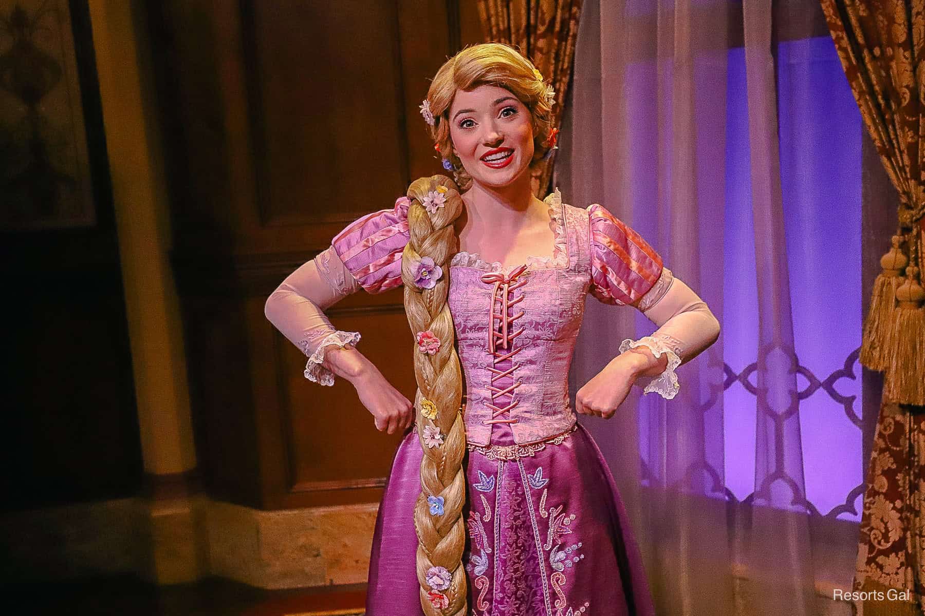 Rapunzel from Tangled in her pink and purple dress with long floral braid. 