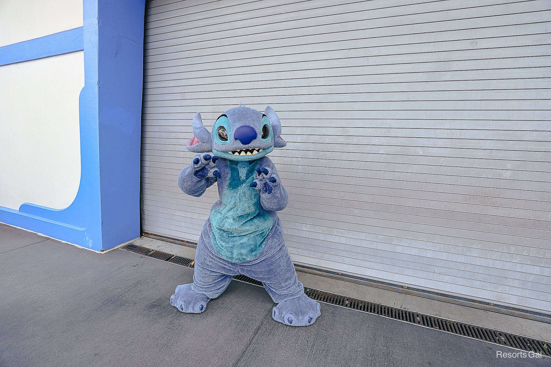 Stitch poses in Tomorrowland near the Buzz Lightyear Space Ranger Spin exit courtyard.