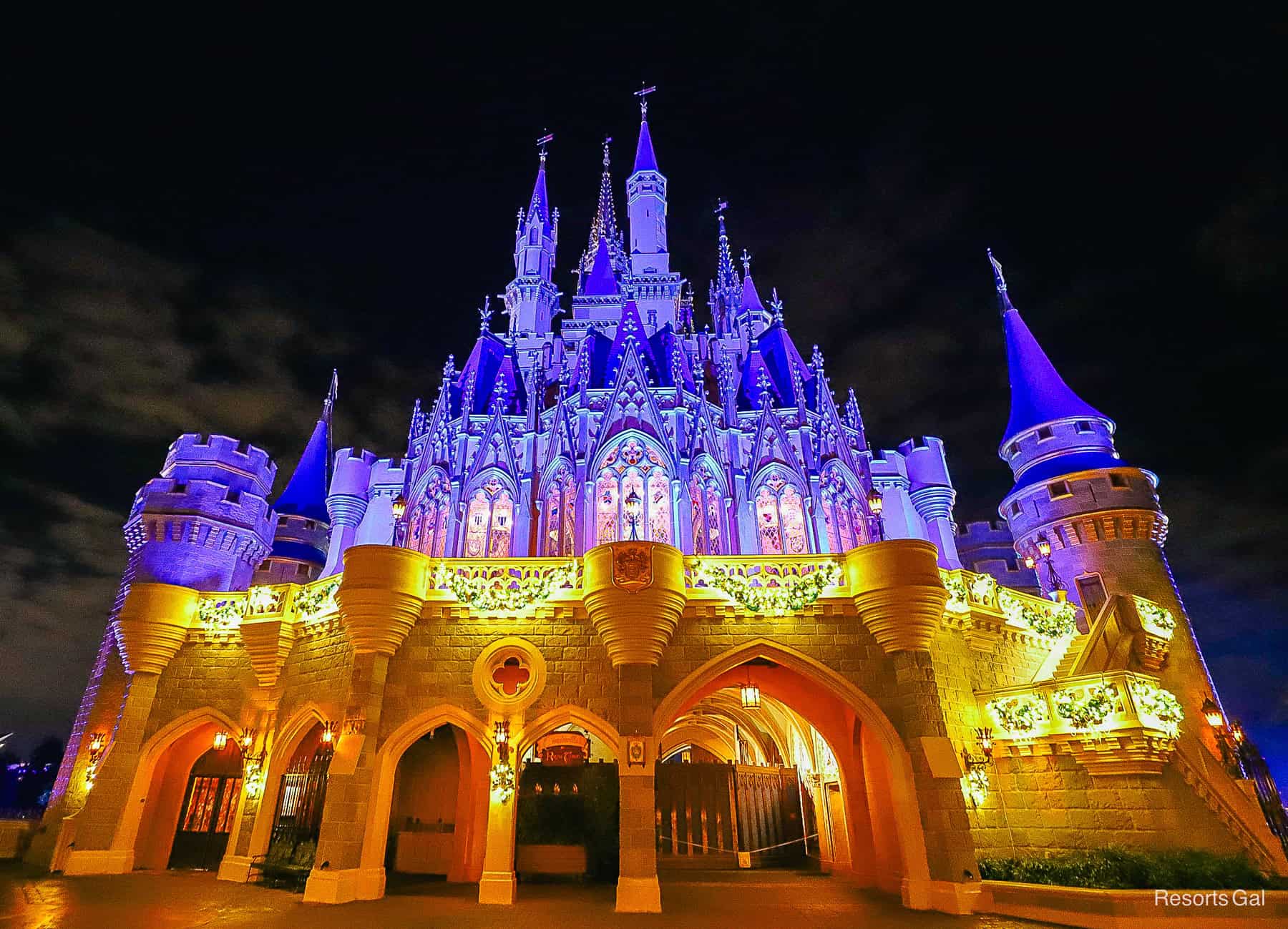 the back of Cinderella Castle glowing at nighttime 